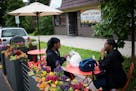 Shanay Ponder, left, brings up something on her phone while she sits with her mother, Inez Howard, at the new parklet seating outside of Twin Cities C