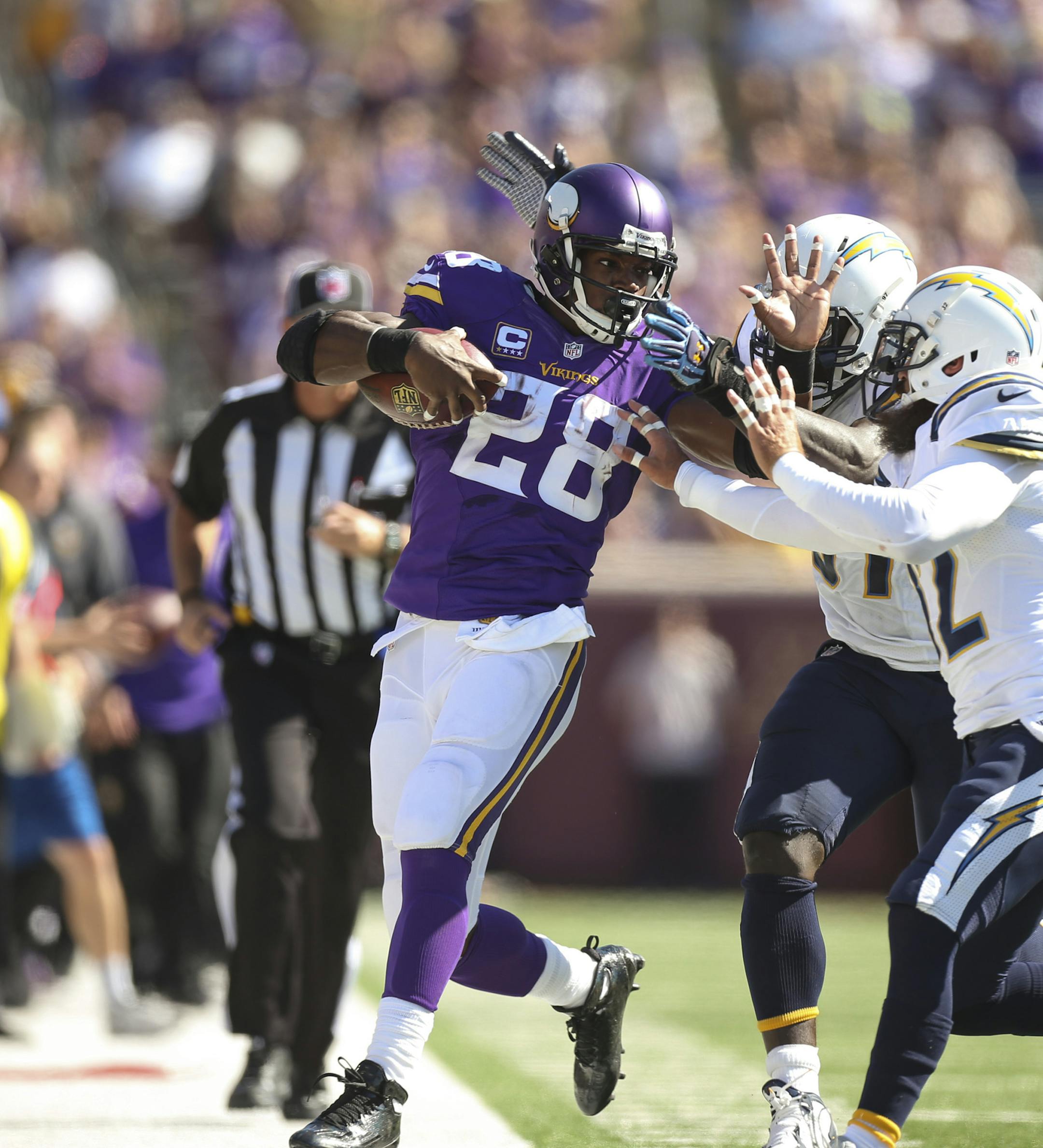 Adrian Peterson was forced out of bounds after a 21 yard run in the first quarter by Chargers outside linebacker Jeremiah Attaochu (97) and strong safety Jahleel Addae (37) Sunday afternoon. ] JEFF WHEELER ï jeff.wheeler@startribune.com The Minnesota Vikings beat the San Diego Chargers 31-14 in an NFL football game Sunday afternoon, September 27, 2015 at TCF Bank Stadium in Minneapolis.