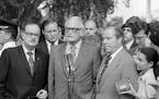 FILE - In this Aug. 7, 1974 file photo, Sen. Barry Goldwater, R-Ariz., center, speaks to reporters after meeting with President Richard Nixon at the W