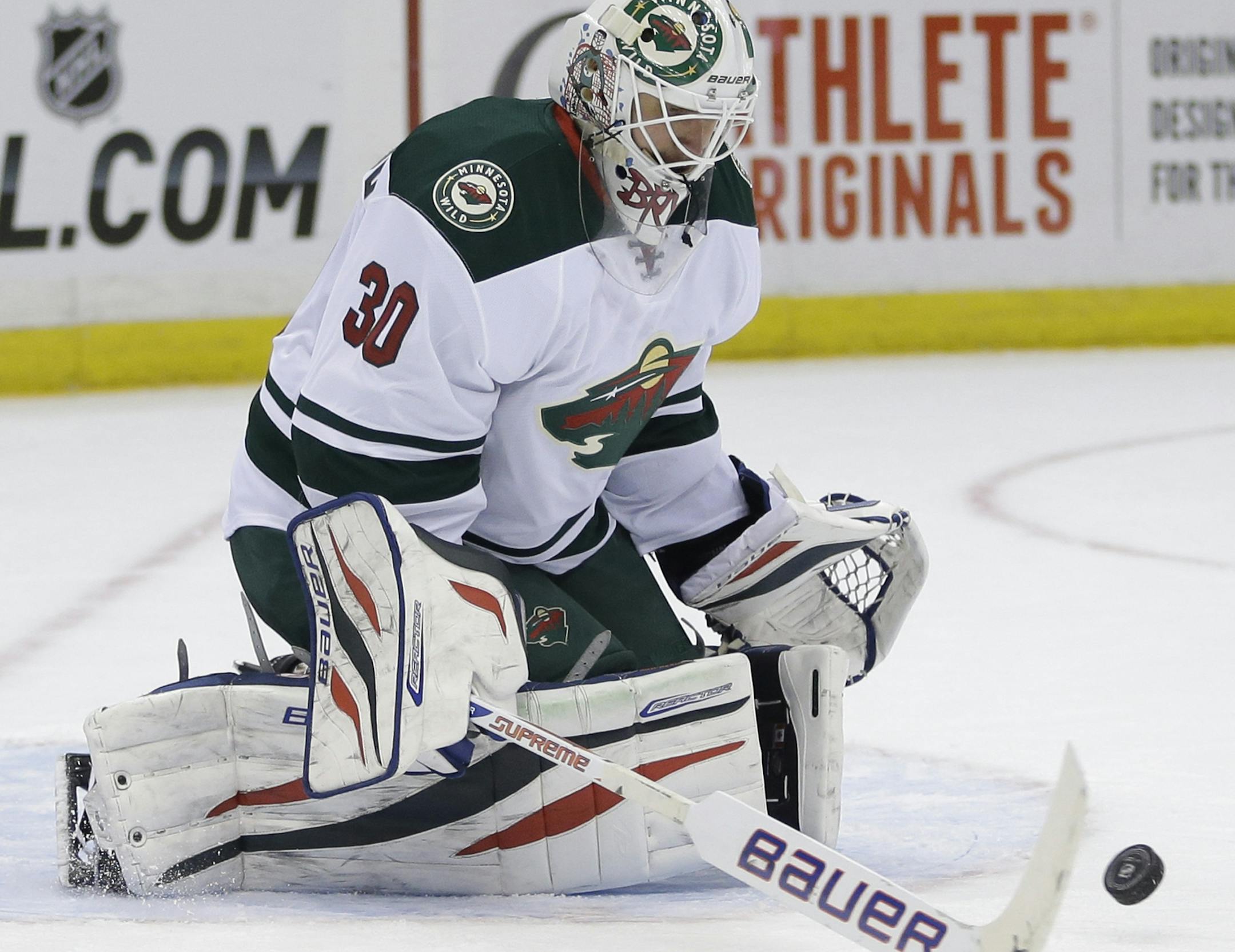 Minnesota Wild goalie Ilya Bryzgalov makes a save during the second period of the NHL hockey game against the New York Islanders, Tuesday, March 18, 2014, in Uniondale, New York. (AP Photo/Seth Wenig)