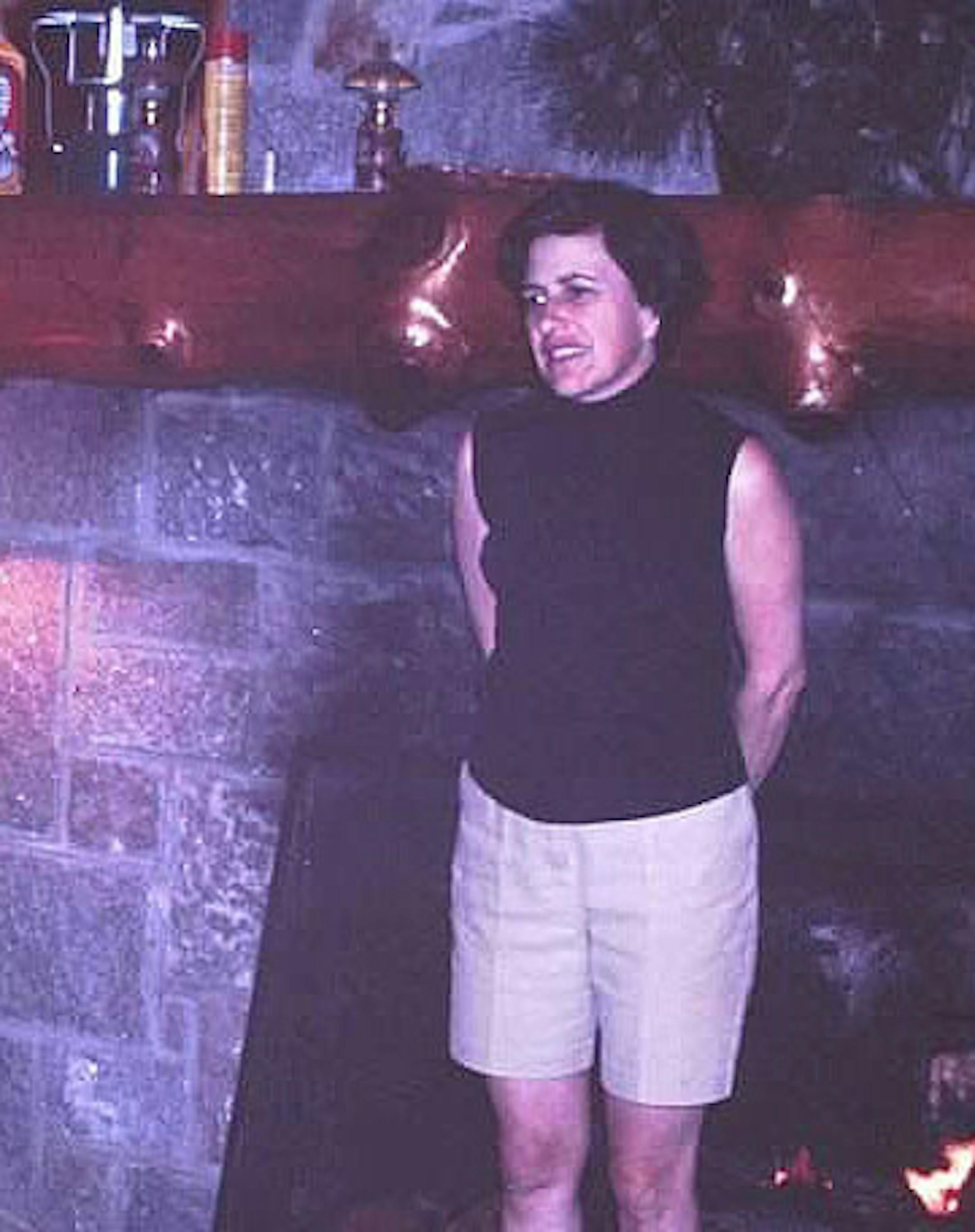 Peluso’s mother, Lorrie, warming in front of the fire in 1969.
