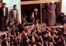 FILE - In this Feb. 2, 1979 file photo, Ayatollah Ruhollah Khomeini, center, is greeted by supporters in Tehran, Iran. Friday, Feb. 1, 2019 marks the 