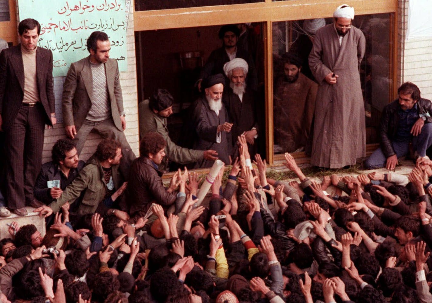 FILE - In this Feb. 2, 1979 file photo, Ayatollah Ruhollah Khomeini, center, is greeted by supporters in Tehran, Iran. Friday, Feb. 1, 2019 marks the 40th anniversary of Iran&#x2019;s exiled Ayatollah Ruhollah Khomeini return to Tehran, a moment that changed the country&#x2019;s history for decades to come. That revolution would spark the U.S. Embassy takeover and hostage crisis, stoking the animosity that exists between Tehran and Washington to this day. (AP Photo, File)