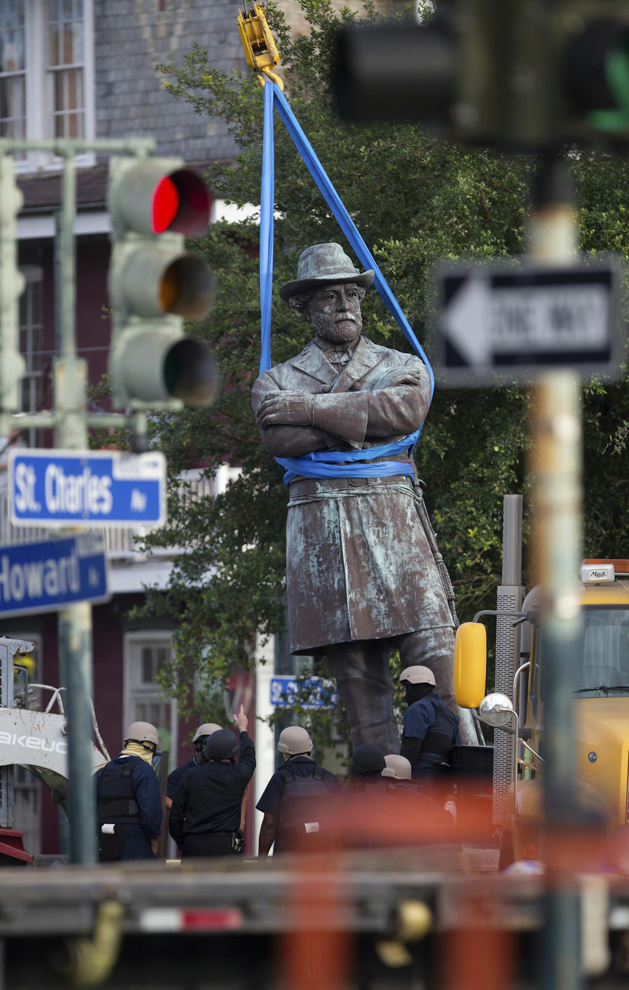 A statue of Confederate General Robert E. Lee is lowered to a truck for removal Friday, May 19, 2017, from Lee Circle in New Orleans. The city council voted to remove the monument and three other Confederate and white supremacist monuments in Dec. 2015. An obelisk honoring the militia known as the White League was taken down in April; a statue of Confederate President Jefferson Davis was removed May 11; and a statue of Confederate General P.G.T. Beauregard was taken down on Wednesday. (AP Photo/