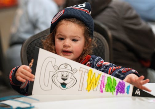 Olivia Reiser, 3, worked on her Twins pennant at the art station.