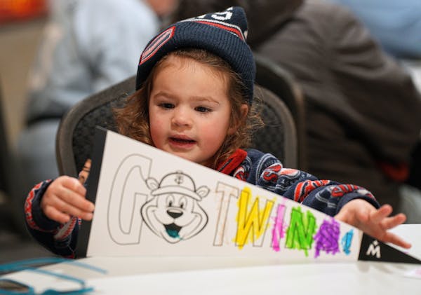 Olivia Reiser, 3, worked on her Twins pennant at the art station.