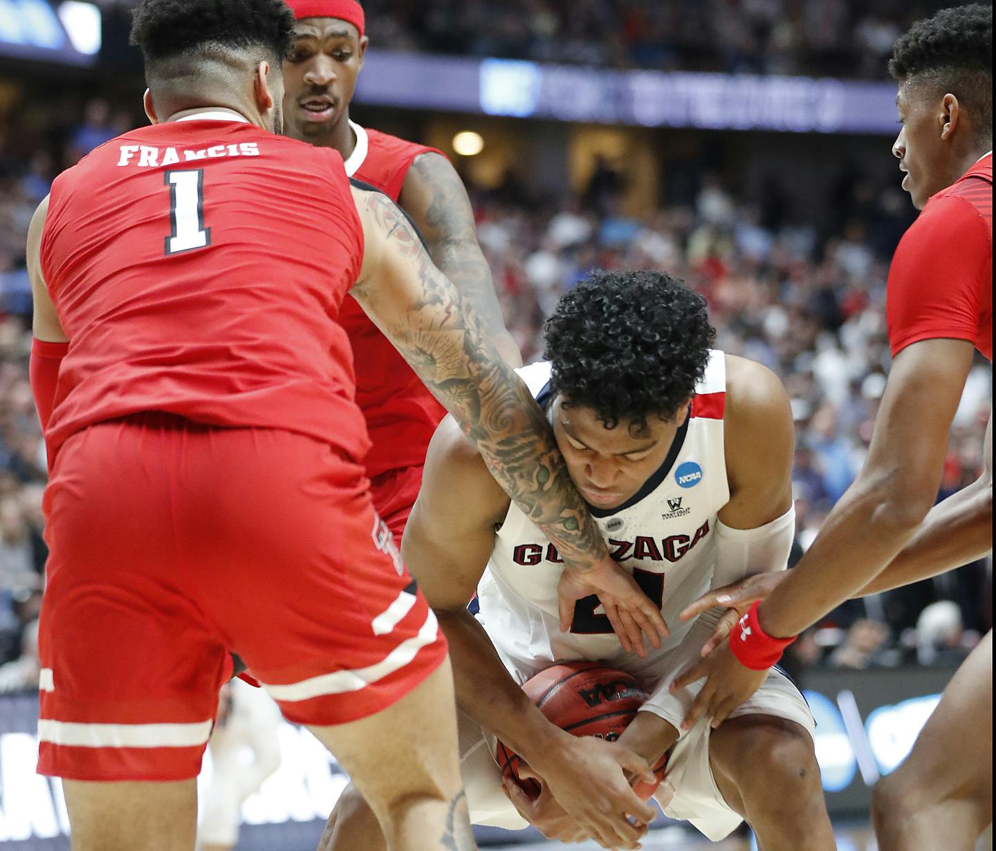 Gonzaga's Rui Hacxhimuira was surrounded by Texas Tech defenders in the West Region final Sunday. The Red Raiders held the potent Zags to 69 points.