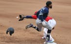 Seattle's J.P. Crawford beat the throw to first base as the Twins' Miguel Sano reaches for he ball during the eighth inning.