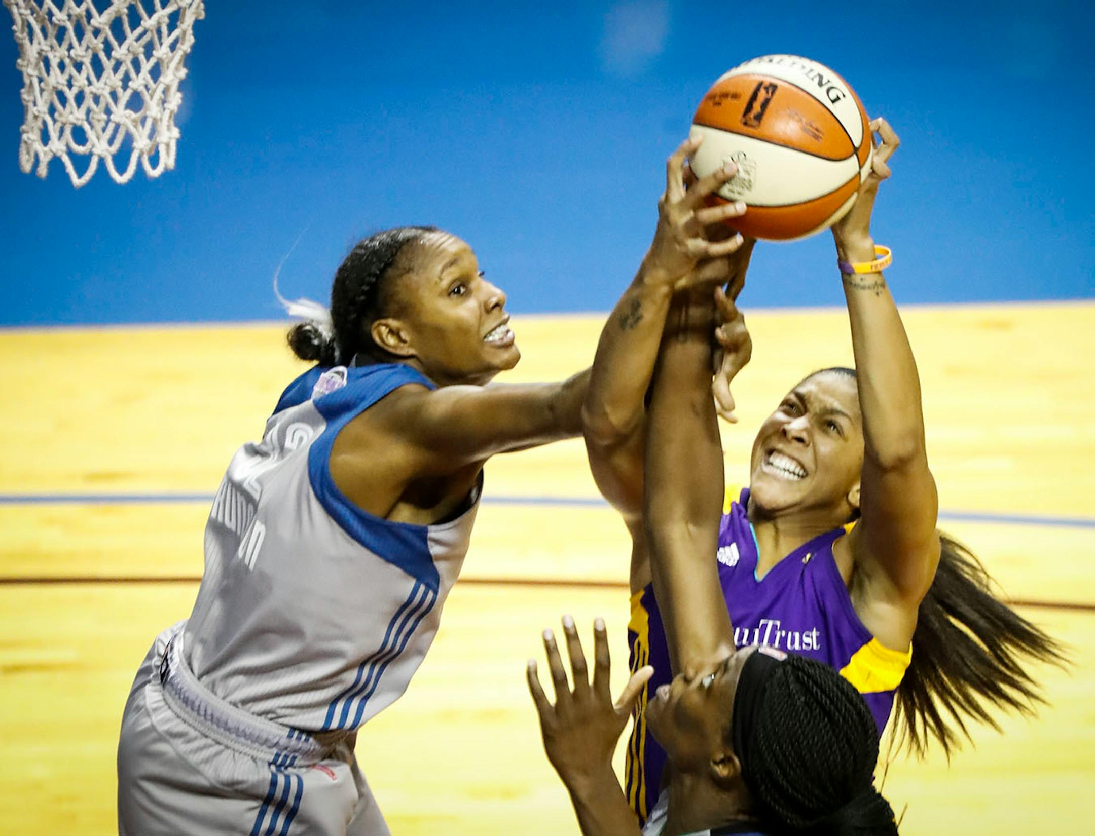 Minnesota Lynx forward Rebekkah Brunson (32) tried to grab a lynx rebound but Los Angeles Sparks forward Candace Parker (3) took control in the second half. The Sparks won 85-84.