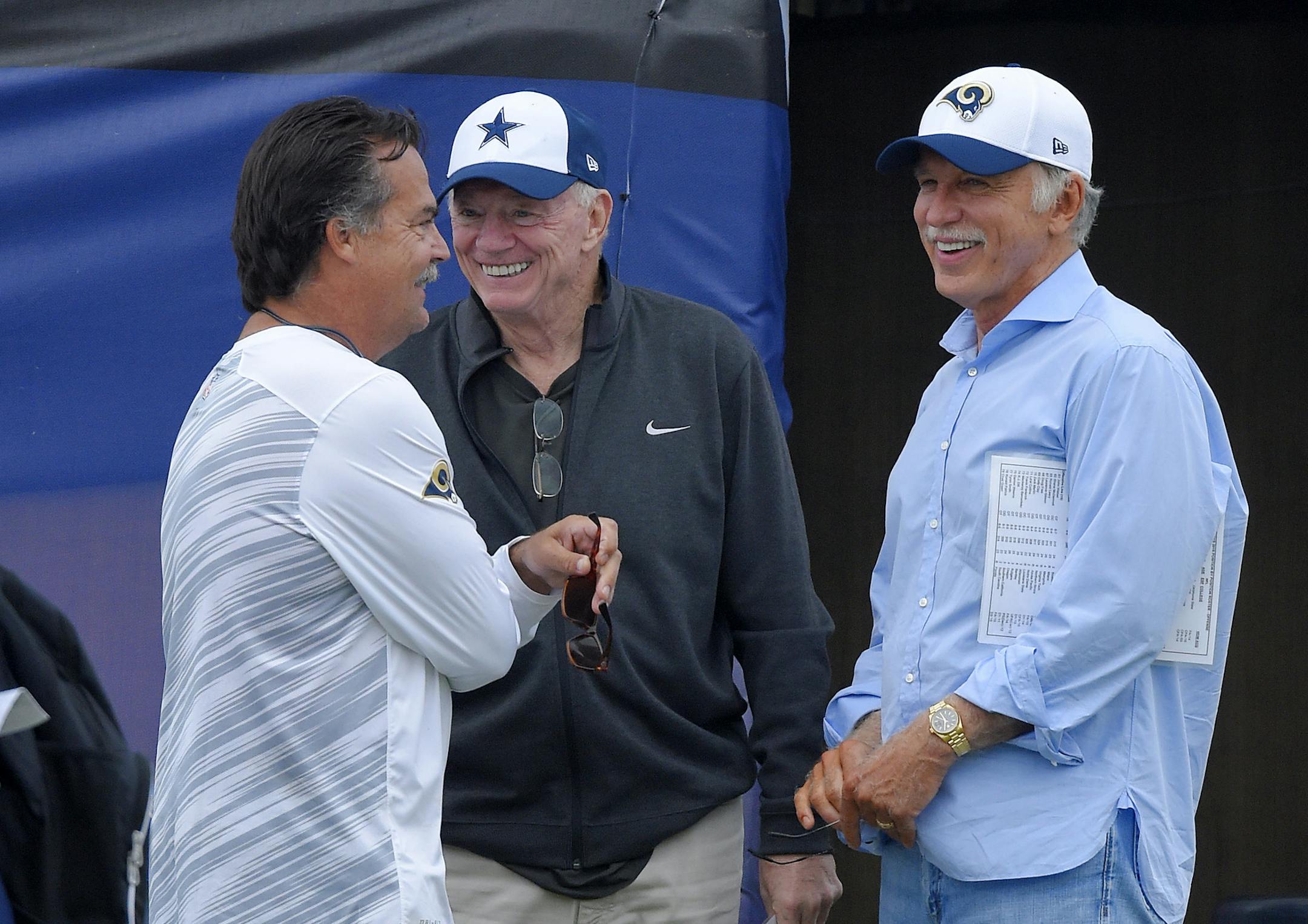 Dallas Cowboys head coach Jeff Fisher, left, talks with Cowboys owner Jerry Jones, center, and St. Louis Rams owner Stan Kroenke, right, talk during a joint NFL football training camp, Monday, Aug. 17, 2015, in Oxnard, Calif. (AP Photo/Mark J. Terrill)