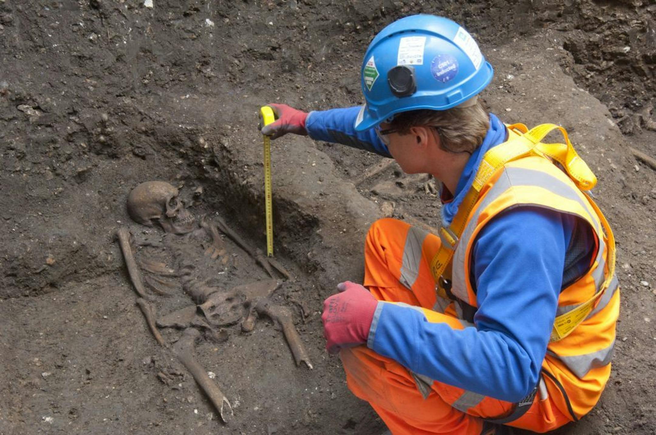 In this undated but recent photo supplied Friday March 15, 2015, by the London Crossrail Project, showing archaeologists working on the UK's largest infrastructure project, Crossrail. Scientists were called in to investigate bones found during the digging of a new railway in central London, after 13 skeletons were found.
