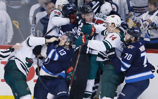 Winnipeg Jets and Minnesota Wild mix it up during the third period of Game 2 of an NHL hockey first-round playoff series Friday, April 13, 2018, in Wi