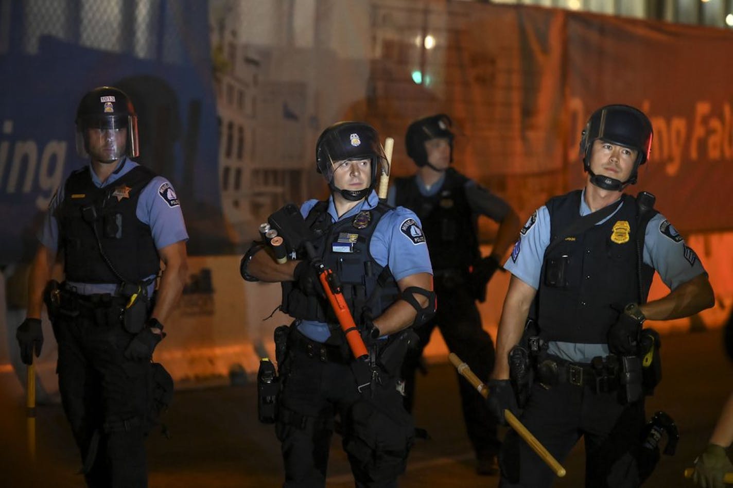 Minneapolis police officers formed a line as they removed a makeshift barricade created by protesters last month.