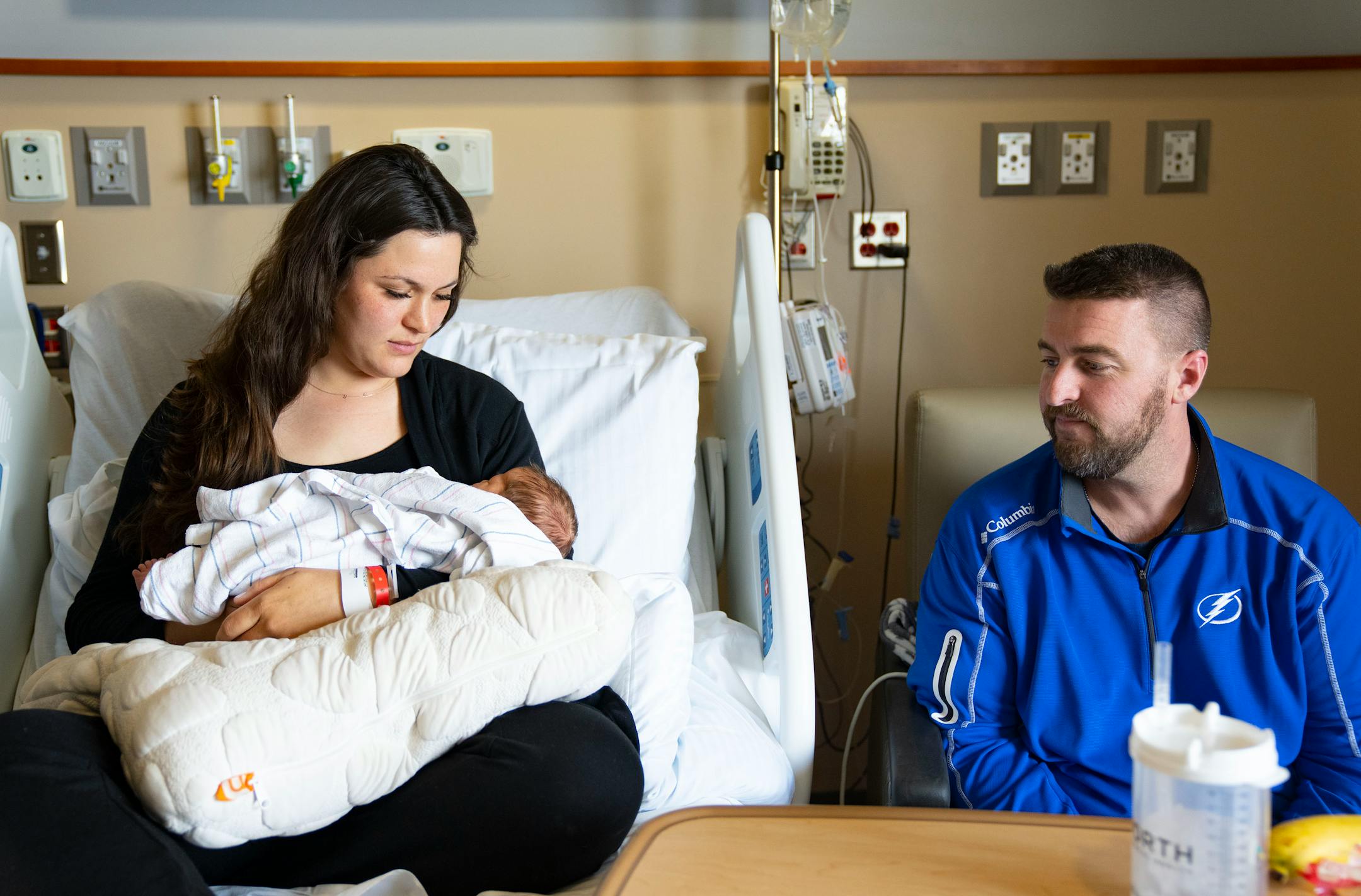 Emily McDonagh holds her newborn daughter, Clare, while her husband, Colin, looks on Thursday, March 24, 2022 at Maple Grove Hospital in Maple Grove, Minn.