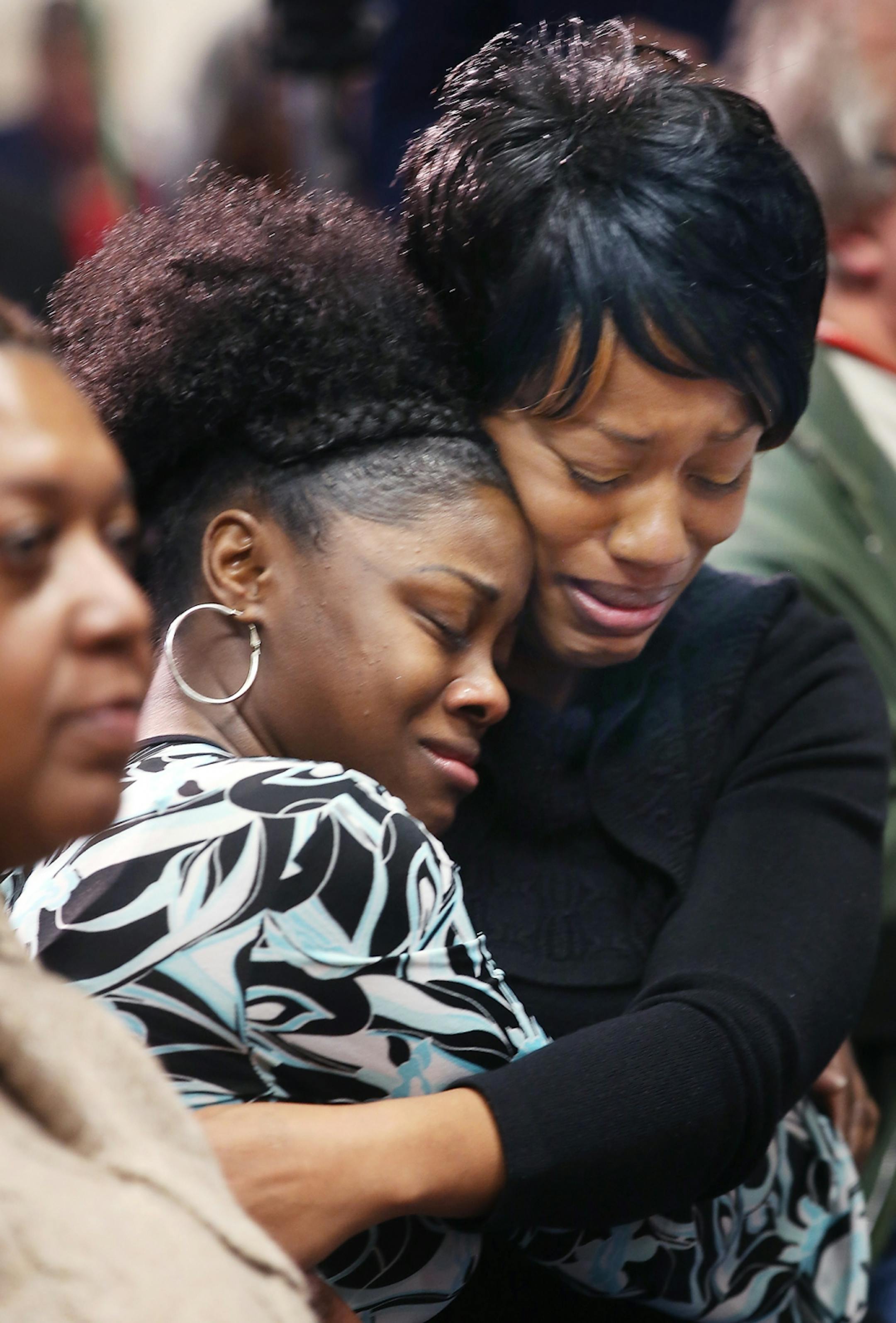 Jamar Clark's family, including his sister Javille Burns, right, hugged Tiffany Burns, his niece, during a press conference regarding Clark's death at the Minneapolis Urban League, Wednesday, November 18, 2015 in Minneapolis, MN.
