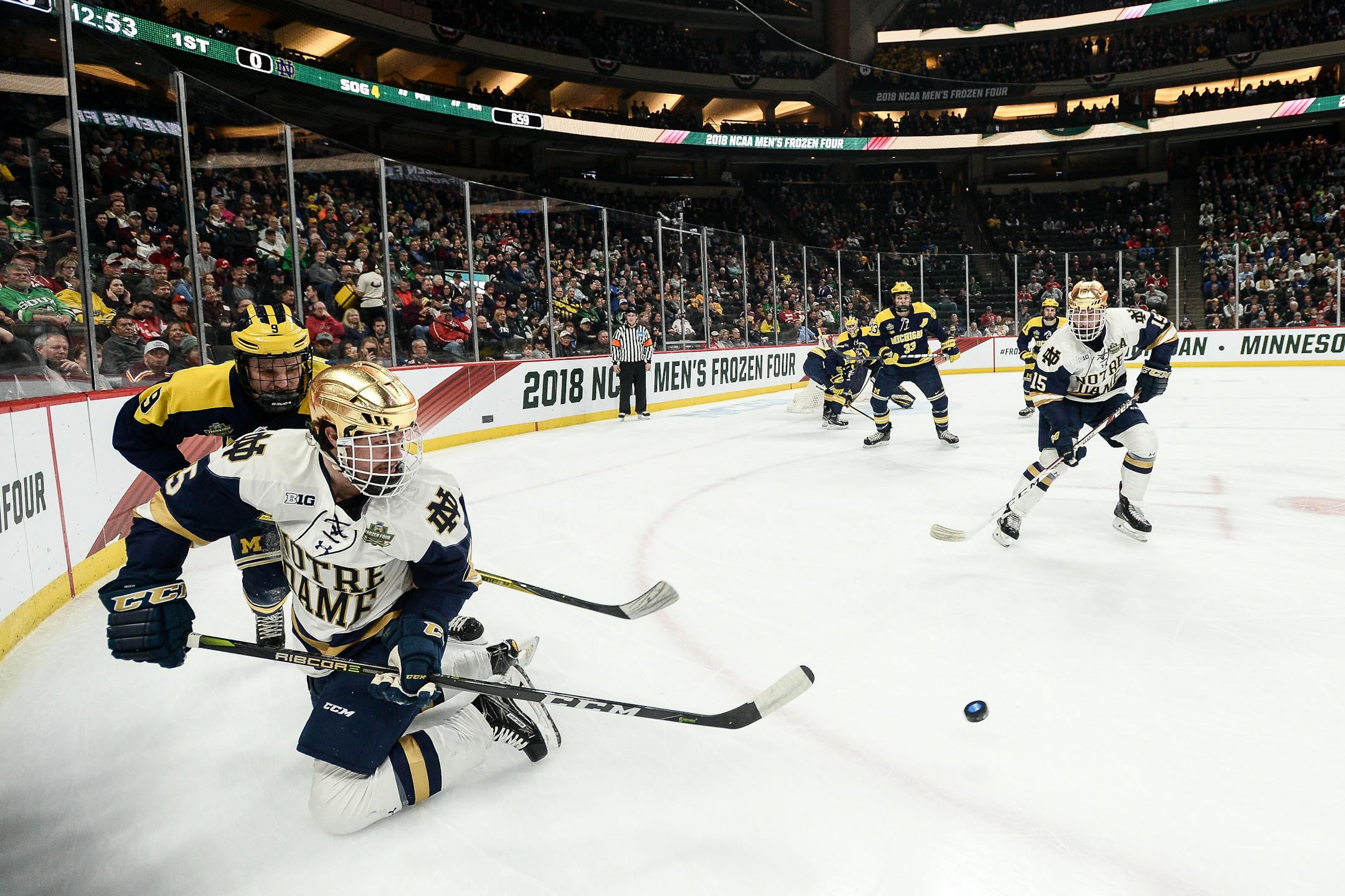 Notre Dame's Dylan Malmquist (25) passed the puck behind his back to teammate Andrew Oglevie on Thursday. Malmquist, of Edina, is one of five Minnesotans on the Irish roster.
