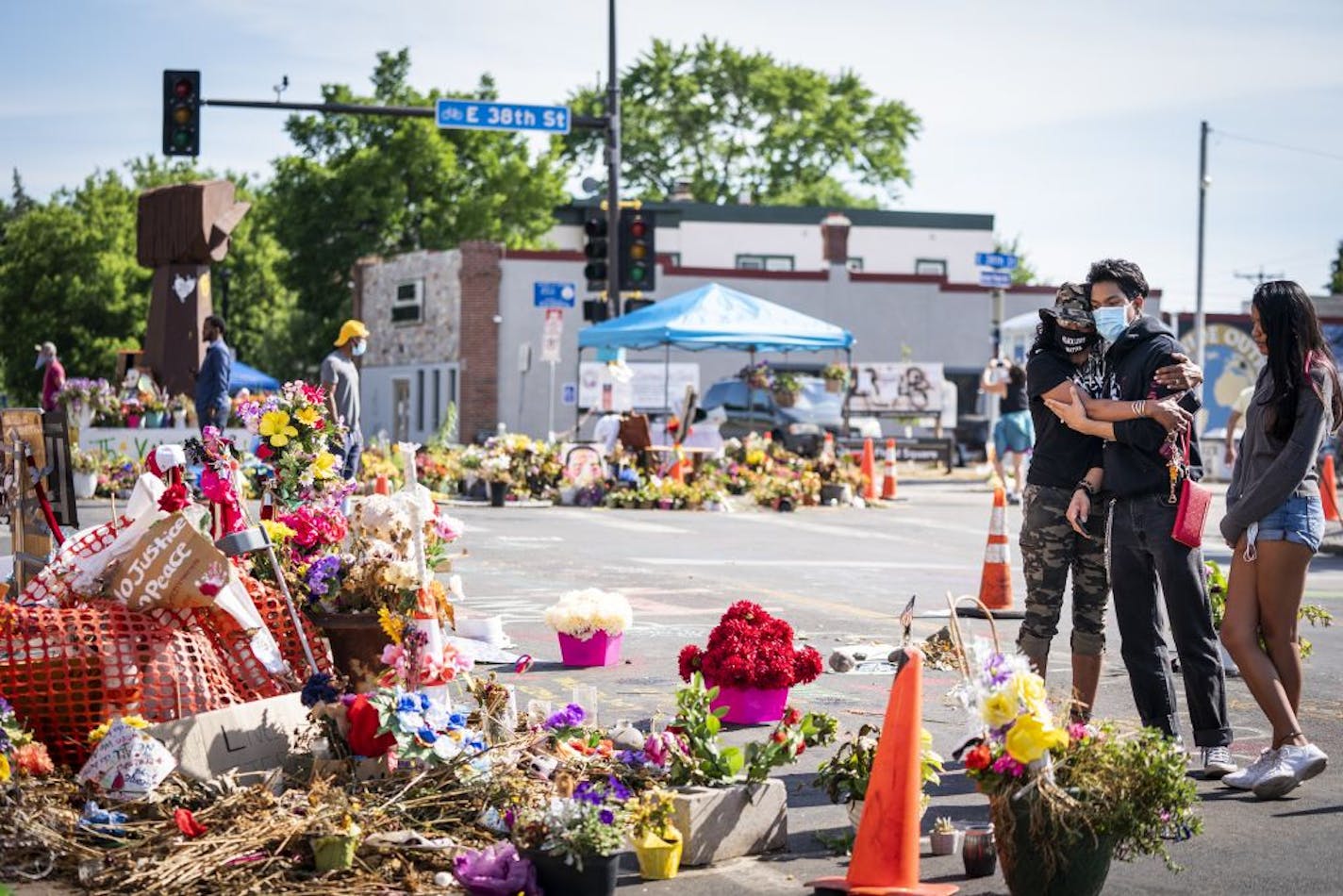 Constance Pearson-Howey, from left, of St. Cloud, with her children Tai Pearson, 16, and Tia Pearson, 17, visited the George Floyd memorial outside Cup Foods.