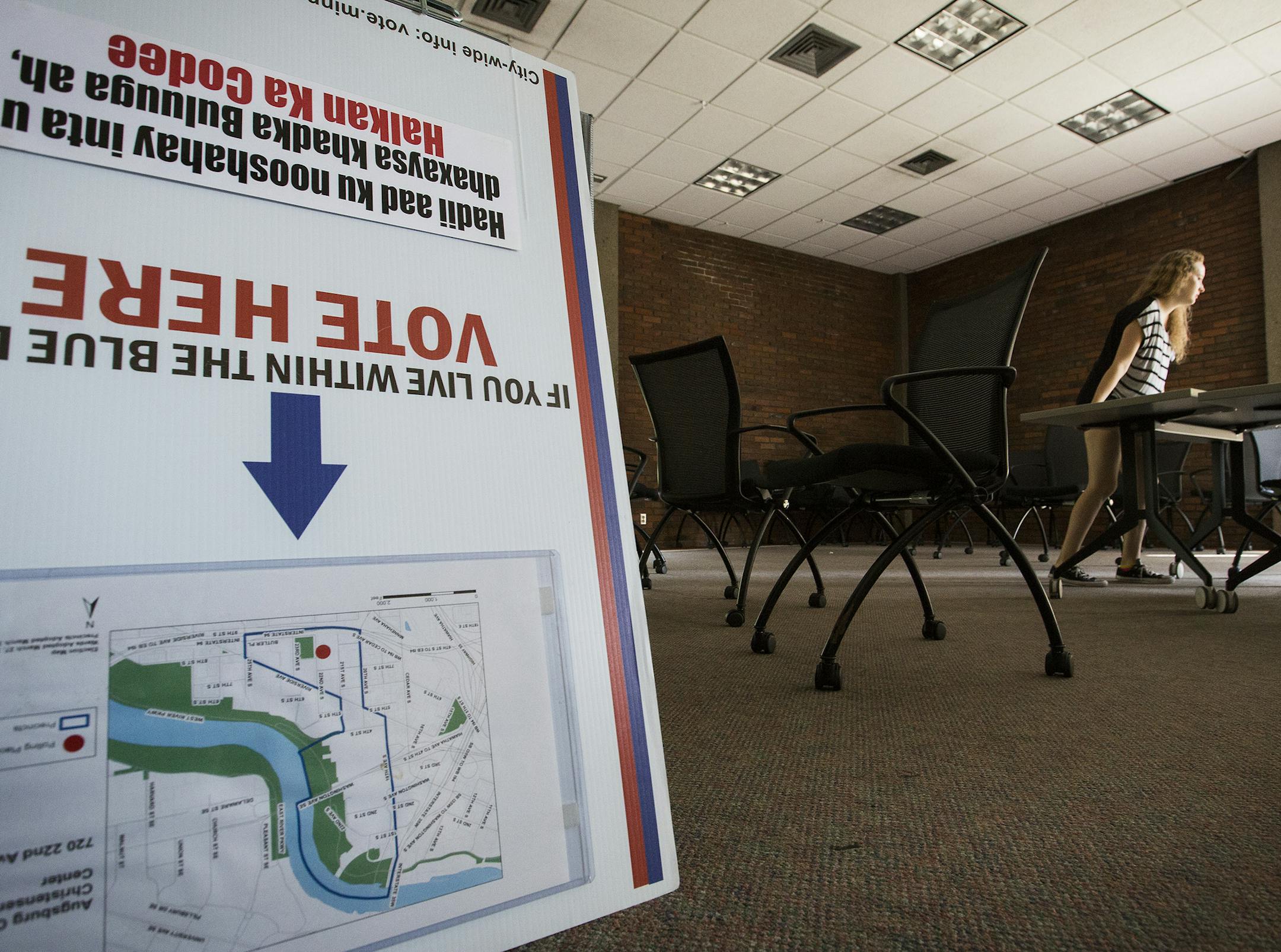 Shanna Frasier, an Augsburg student, set up tables inside a polling place at Christensen Center at Augsburg College before Tuesday's primary election.
