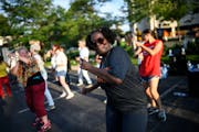 Tracy Gordon, of Minneapolis, danced in a parking lot near the American Swedish Institute on Tuesday night.
