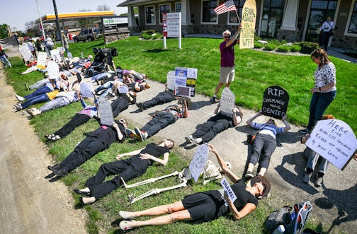 Demonstrators gathered at the Burnsville offices of Minnesota Republican congressman Jason Lewis in the wake of his vote on Thursday to repeal and replace Obamacare. At Lewis's office in Burnsville they are calling their protest a "die-in."