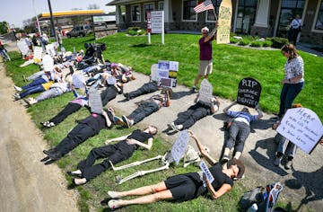 Demonstrators gathered at the Burnsville offices of Minnesota Republican congressman Jason Lewis in the wake of his vote on Thursday to repeal and rep