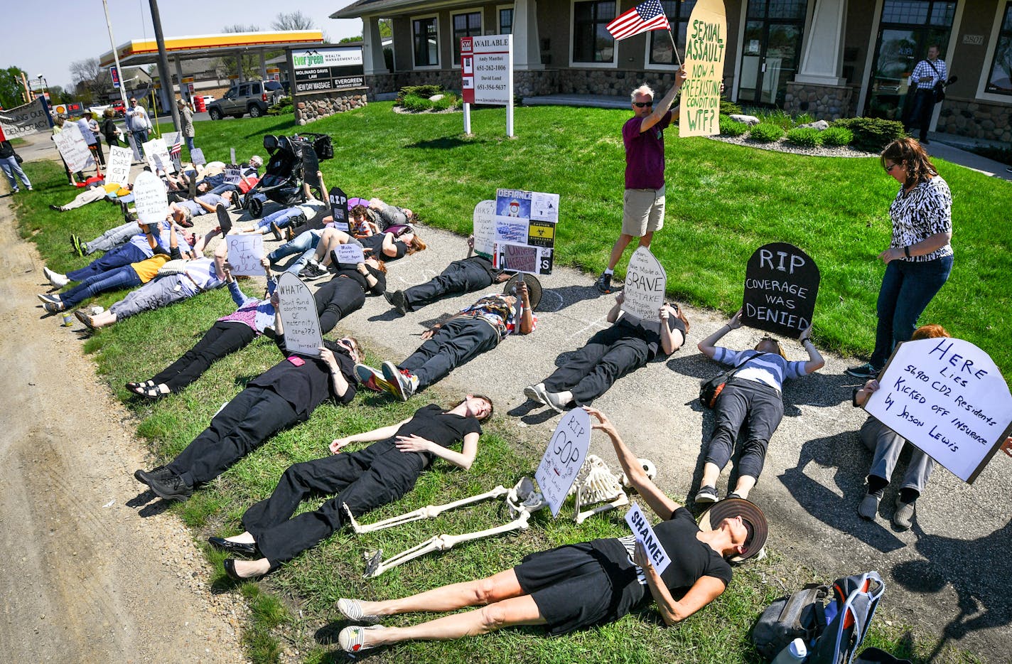 Demonstrators gathered at the Burnsville offices of Minnesota Republican congressman Jason Lewis in the wake of his vote on Thursday to repeal and replace Obamacare. At Lewis's office in Burnsville they are calling their protest a "die-in."