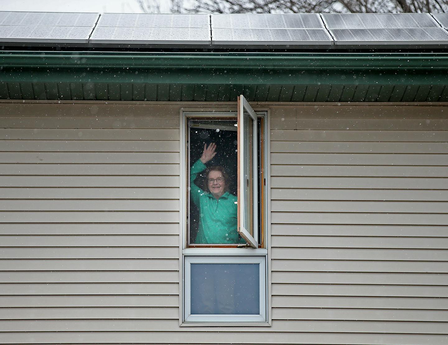 Alice Ellison waved goodbye from her home, Tuesday, April 21, 2015 in Plymouth, MN. For her 90th birthday Ellison's gift to the planet at the start of her tenth decade is the array of solar panels installed last week on the roof of her Plymouth home. Before the solar panels, Ellison depended mostly on light coming from her windows and doors. ] (ELIZABETH FLORES/STAR TRIBUNE) ELIZABETH FLORES &#x2022; eflores@startribune.com