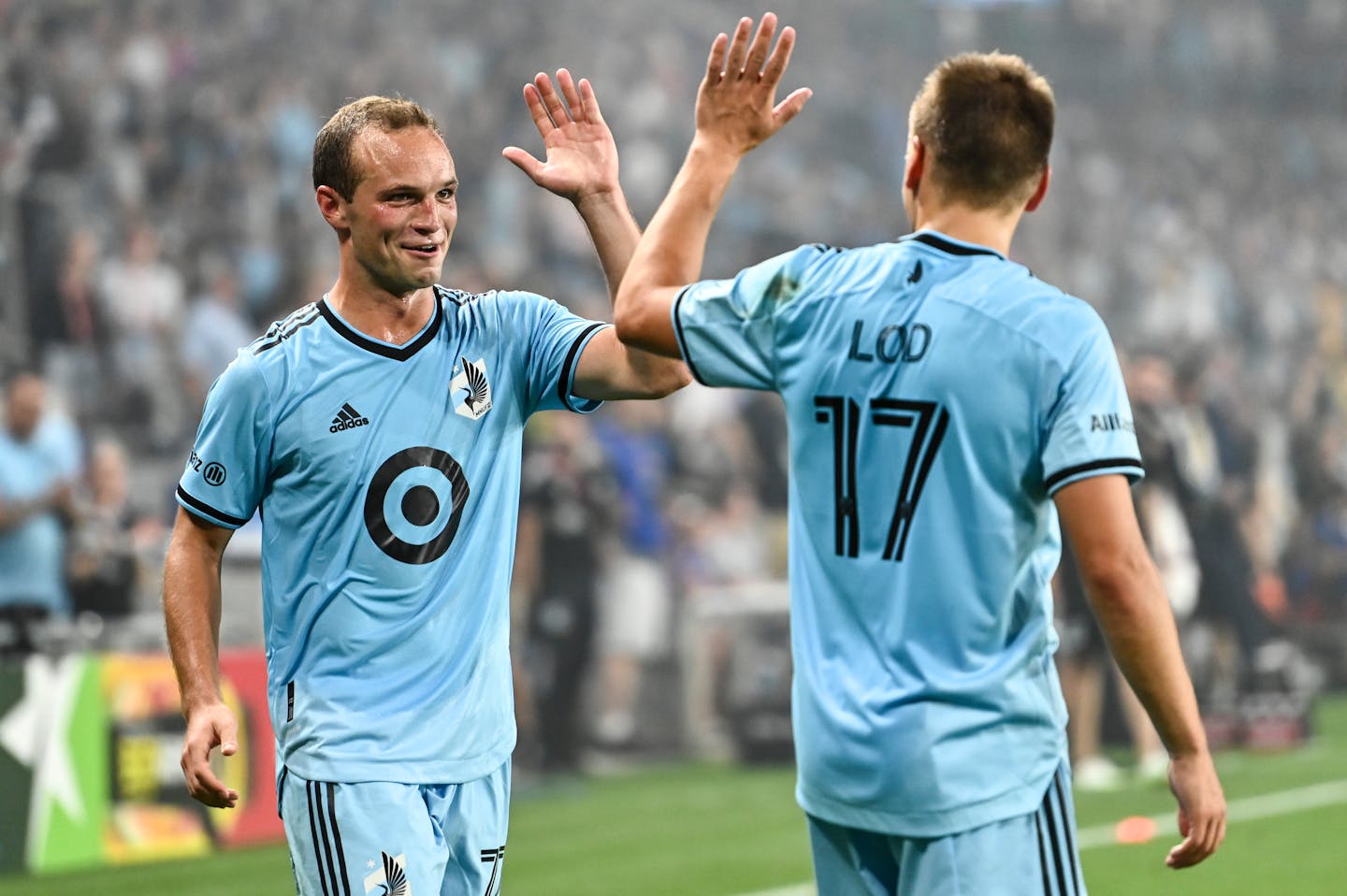 Minnesota United defender Chase Gasper (77) and midfielder Robin Lod (17).