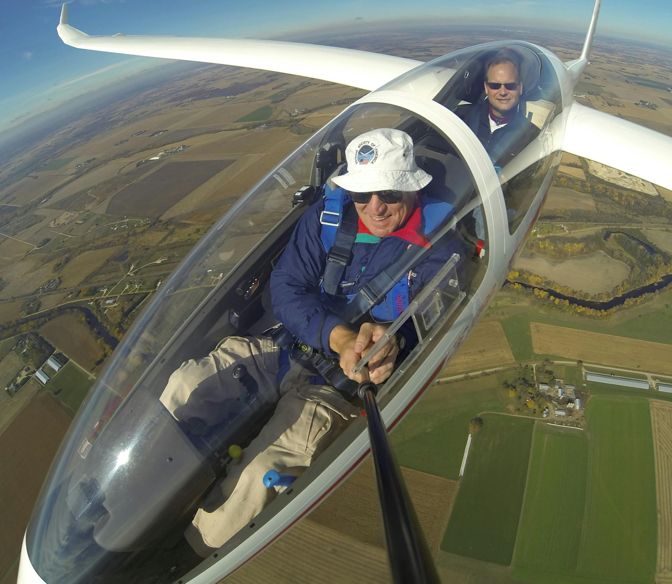 Lou Chouinard, left, and friend and fellow glider pilot Paul Remde flying above the Stanton Airfield in Stanton, Minn.