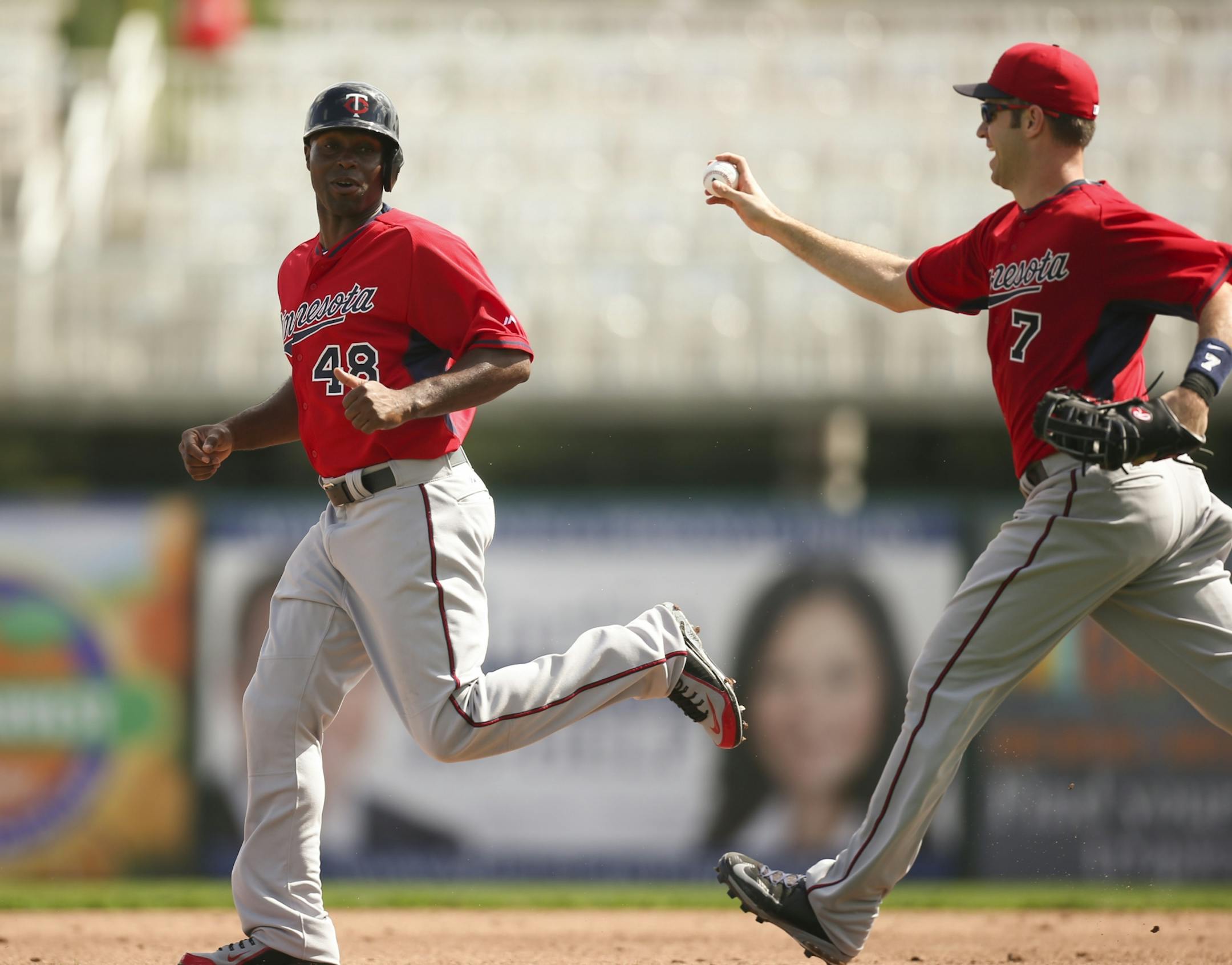 Twins outfielder Torii Hunter tried to elude first baseman Joe Mauer (7) during a drill Monday morning at Hammond Stadium.