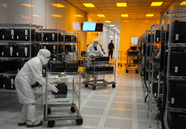 Polar Semiconductor employees work in one of three fabrication areas inside the company’s expansive clean room in Bloomington.