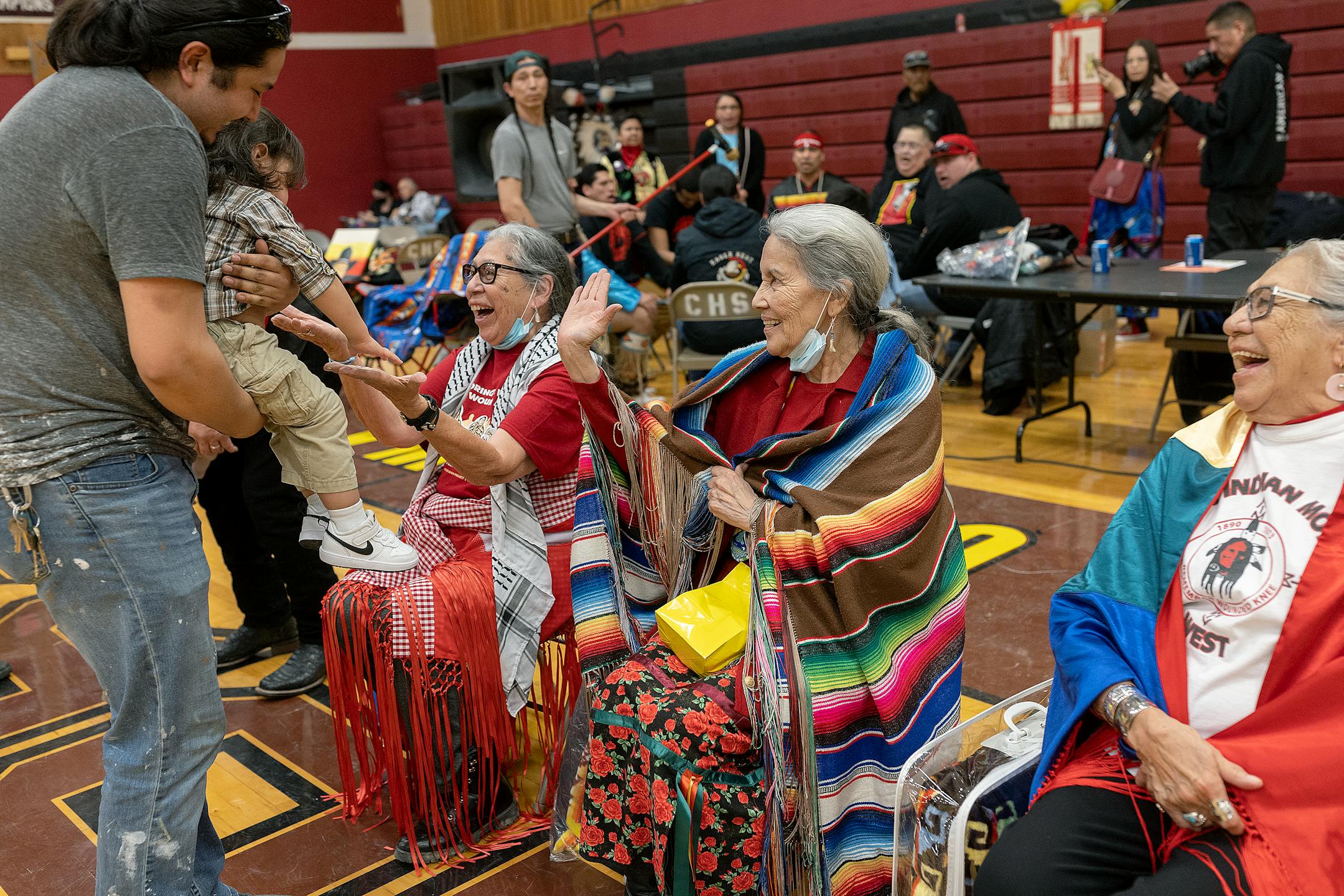 Women of Wounded Knee, Madonna Thunder Hawk, left, Yvonne Swan, center, and Mable Eagle Speaker, are greeted by guests during a Pow Wow to honor the AIM Warriors of Wounded Knee of 1973 in Wanblee, SD on the Pine Ridge Indian Reservation.