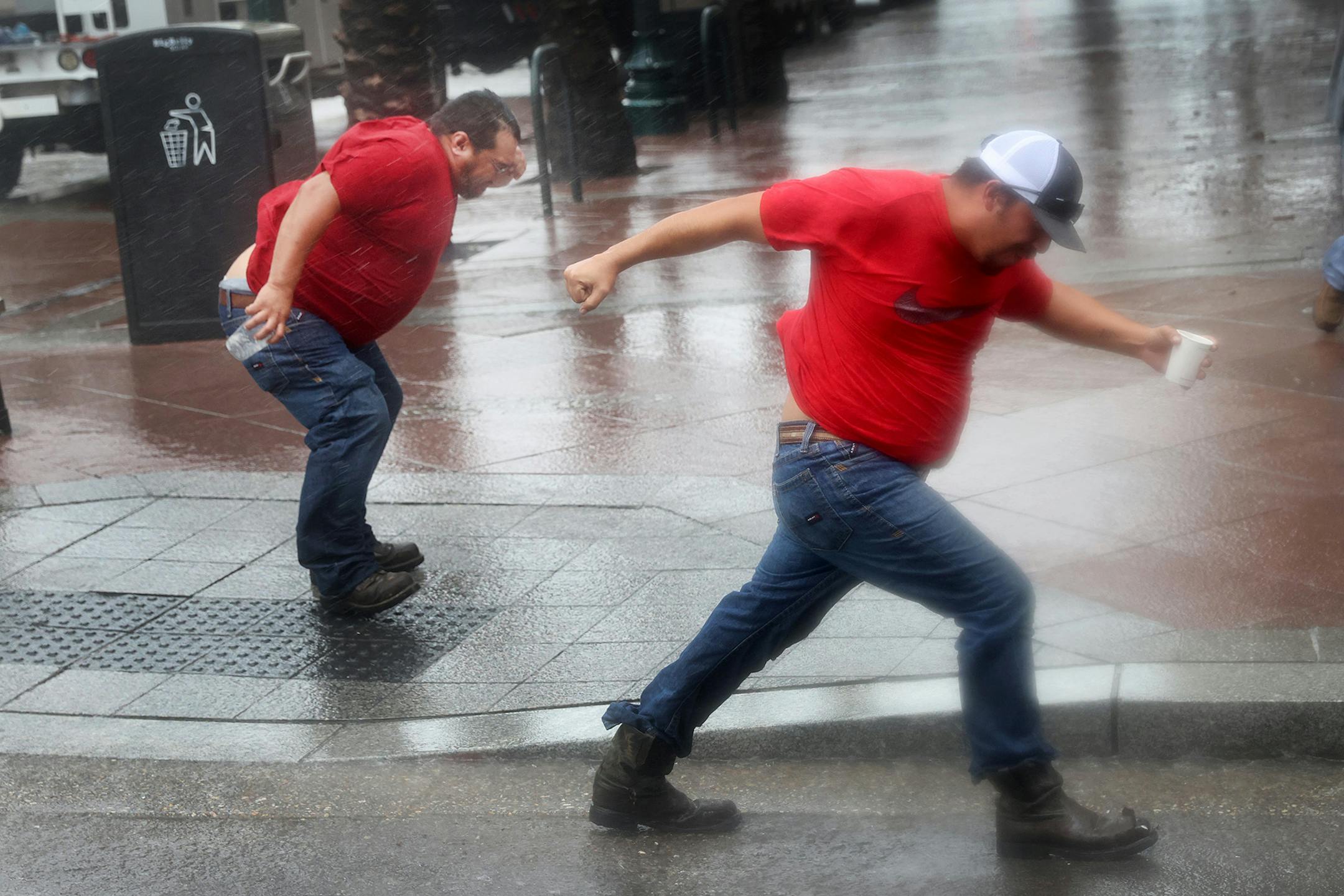 Utility workers play in the wind from Hurricane Ida as they wait for the storm to pass to begin repairs on August 29, 2021 in New Orleans, Louisiana. Ida made landfall earlier today southwest of New Orleans.  (Scott Olson/Getty Images/TNS) ORG XMIT: 25603654W