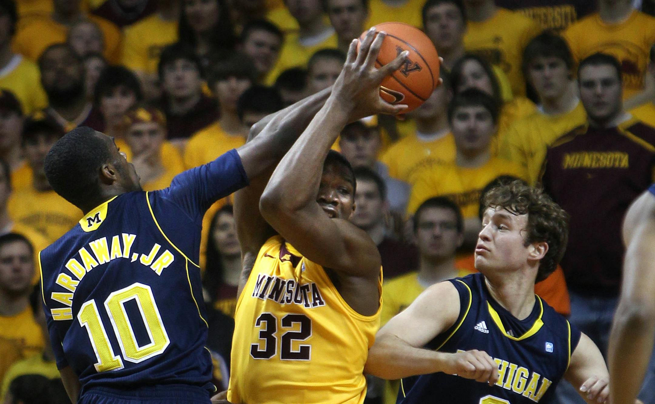 Minnesota's Trevor Mbakwe (middle) fought for control of the ball against Michigan's Tim Hardaway Jr. (left) and Zack Novak.