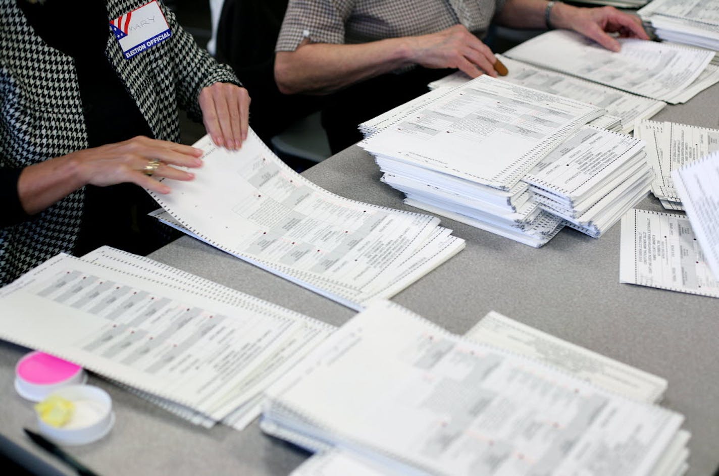 Ramsey County election officials count ballots into piles of 25 on Friday.