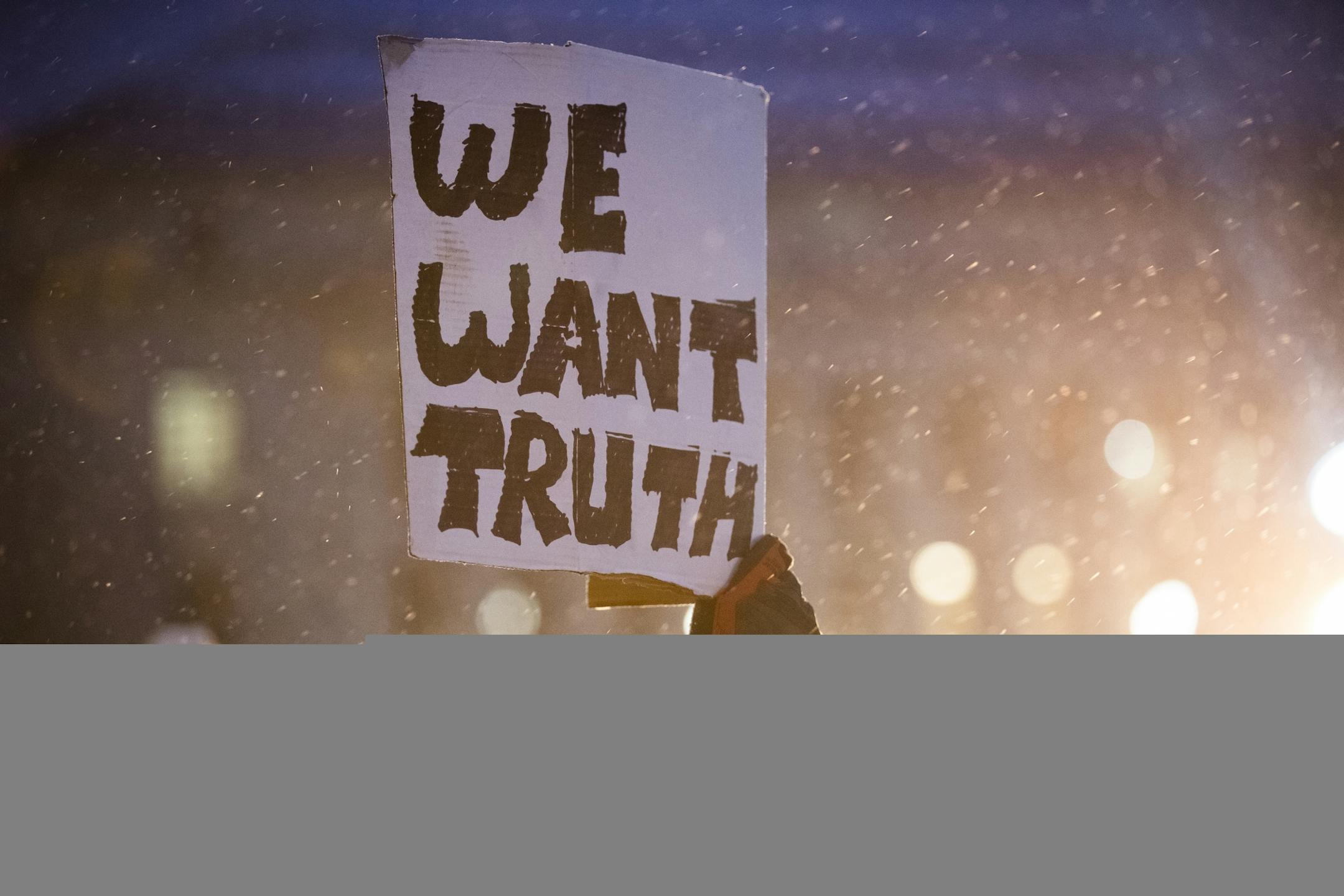 A protester holds a sign at a protest in support of Special Counsel Robert Mueller's investigation.