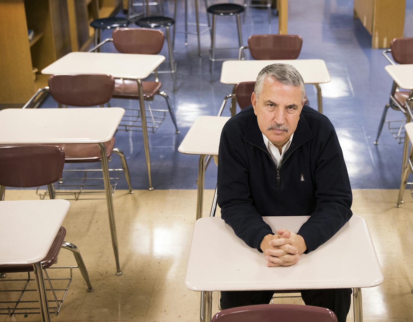 New York Times columnist Thomas Friedman poses for a photo while sitting in his old seat in his old journalism classroom at St. Louis Park High School. ] (Leila Navidi/Star Tribune) leila.navidi@startribune.com BACKGROUND INFORMATION: New York Times columnist Thomas Friedman visits his old high school journalism classroom at St. Louis Park High School on Monday, December 12, 2016.