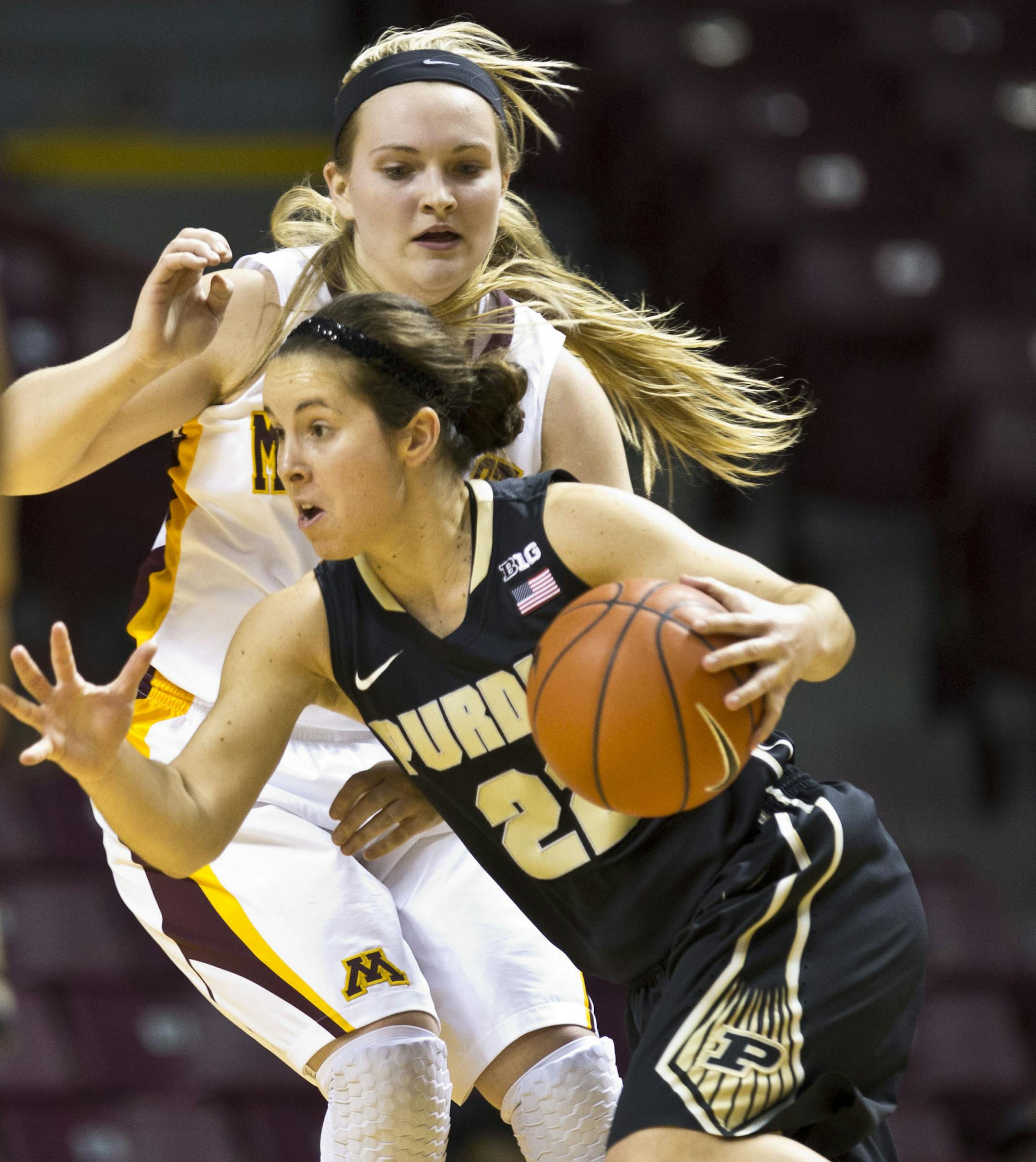 Purdue's Courtney Moses charged past Gophers' 21 Sari Noga during the second half of the Women's Gopher basketball against Perdue on Thursday, February 20, 2014 at WIlliams Arena in Minneapolis, Minn. Moses scored 27 points. Perdue won 63-42. ] (RENEE JONES SCHNEIDER reneejones@startribune.com)