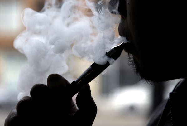 FILE - In this April 23, 2014, file photo, an electronic cigarette is demonstrated in Chicago. In a surprising new policy statement, the American Hear