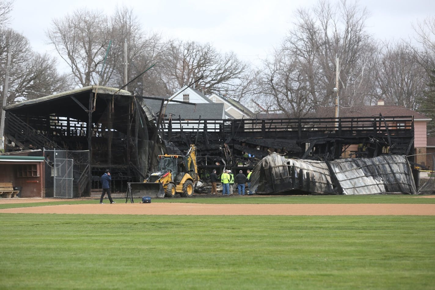 The charred remains of the grandstand at Tink Larson field in Waseca, Minn.