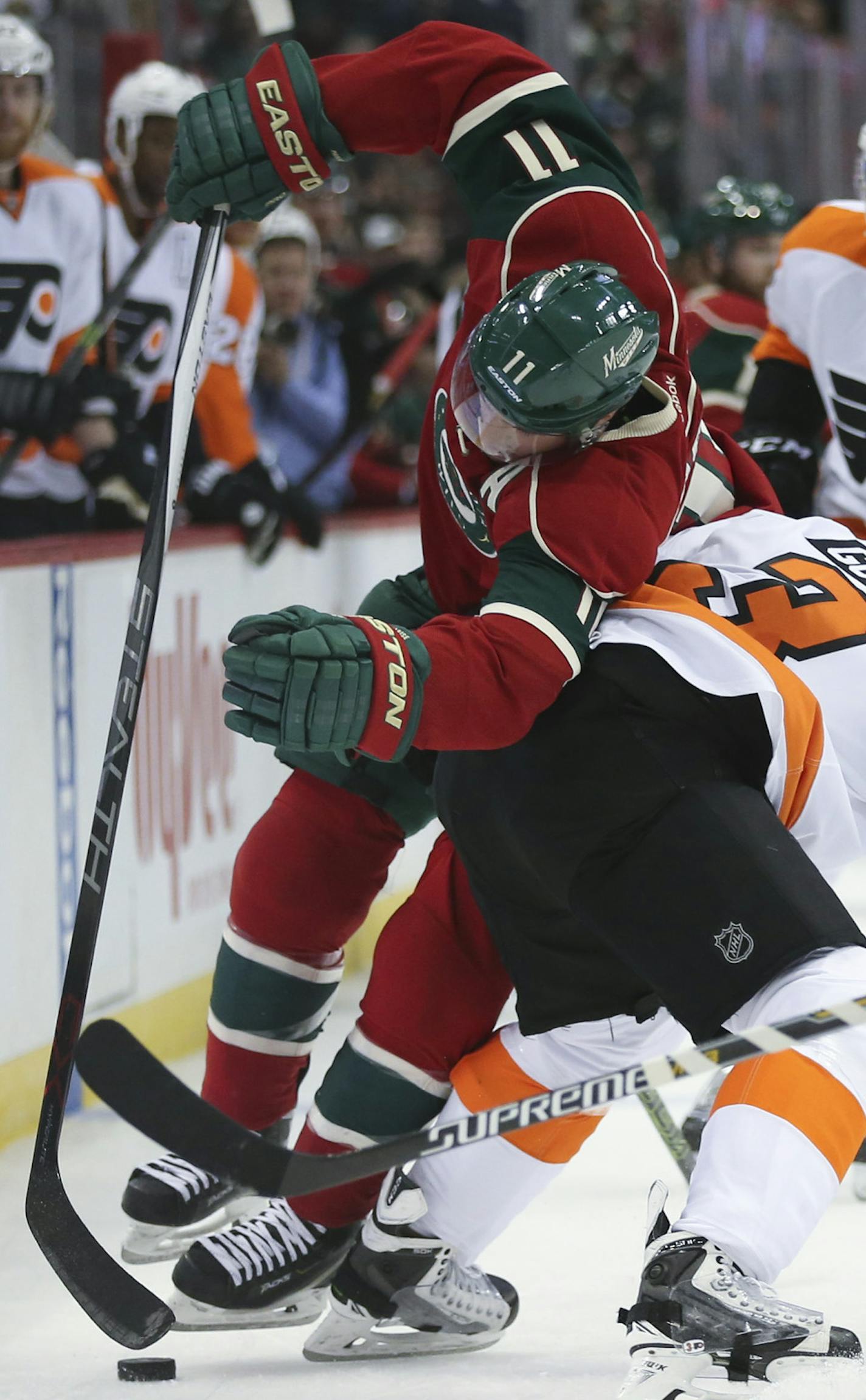 Wild left wing Zach Parise (11) was checked off the puck by Philadelphia Flyers defenseman Radko Gudas (3) in the first period Thursday night.