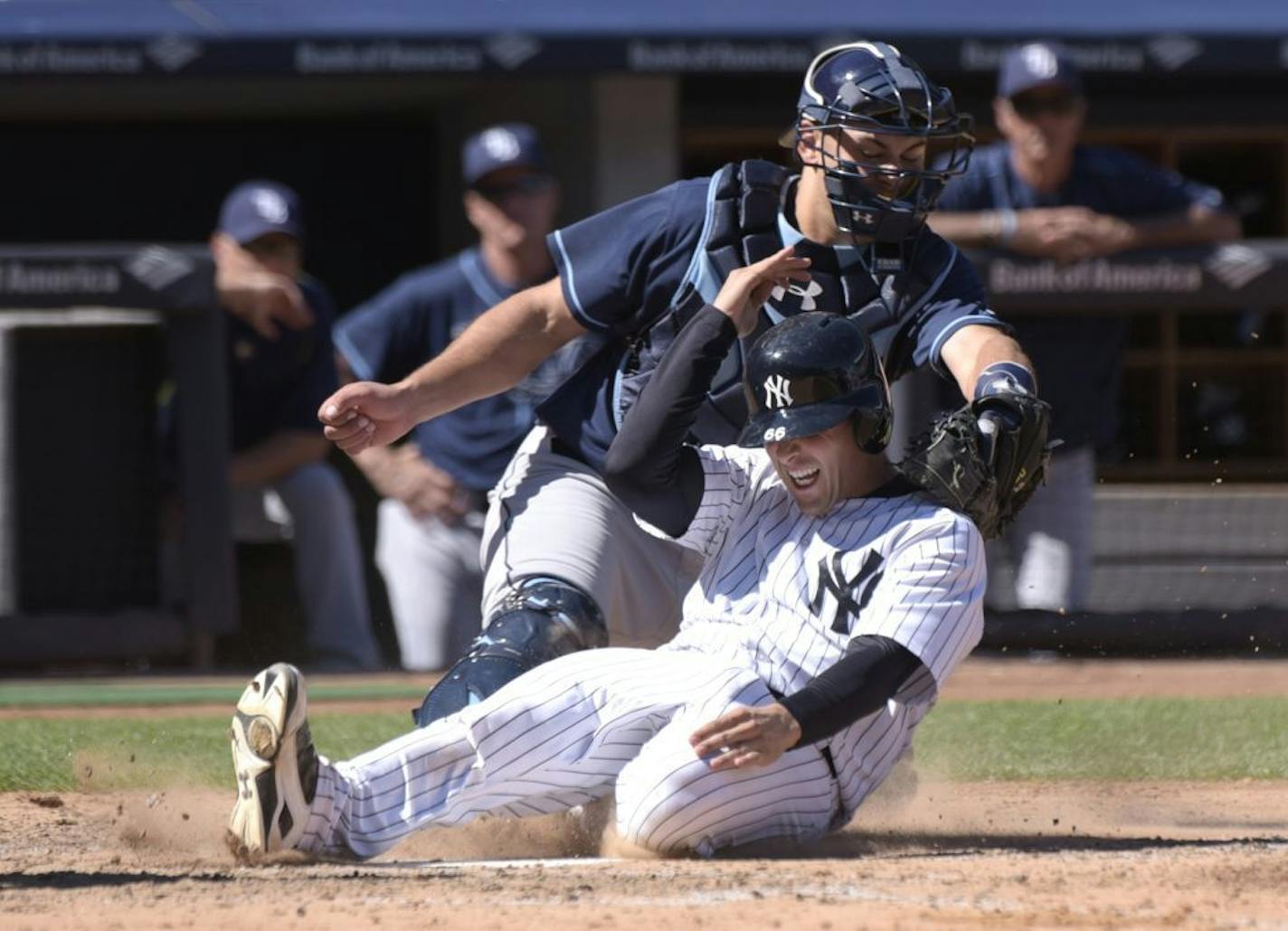 New York Yankees' John Ryan Murphy (66) scores on a double by Didi Gregorius ahead of the tag by Tampa Bay Rays catcher Luke Maile during the fifth inning of a baseball game Saturday, Sept. 5, 2015, at Yankee Stadium in New York.