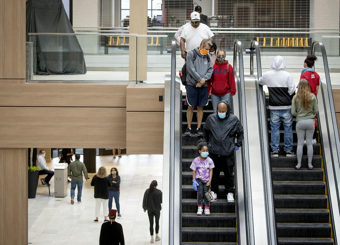 Shoppers made their way through Rosedale Center as some of the stores opened for business during the coronavirus pandemic, Monday, May 18, 2020 in Roseville, Minn. (Elizabeth Flores/Star Tribune via AP)