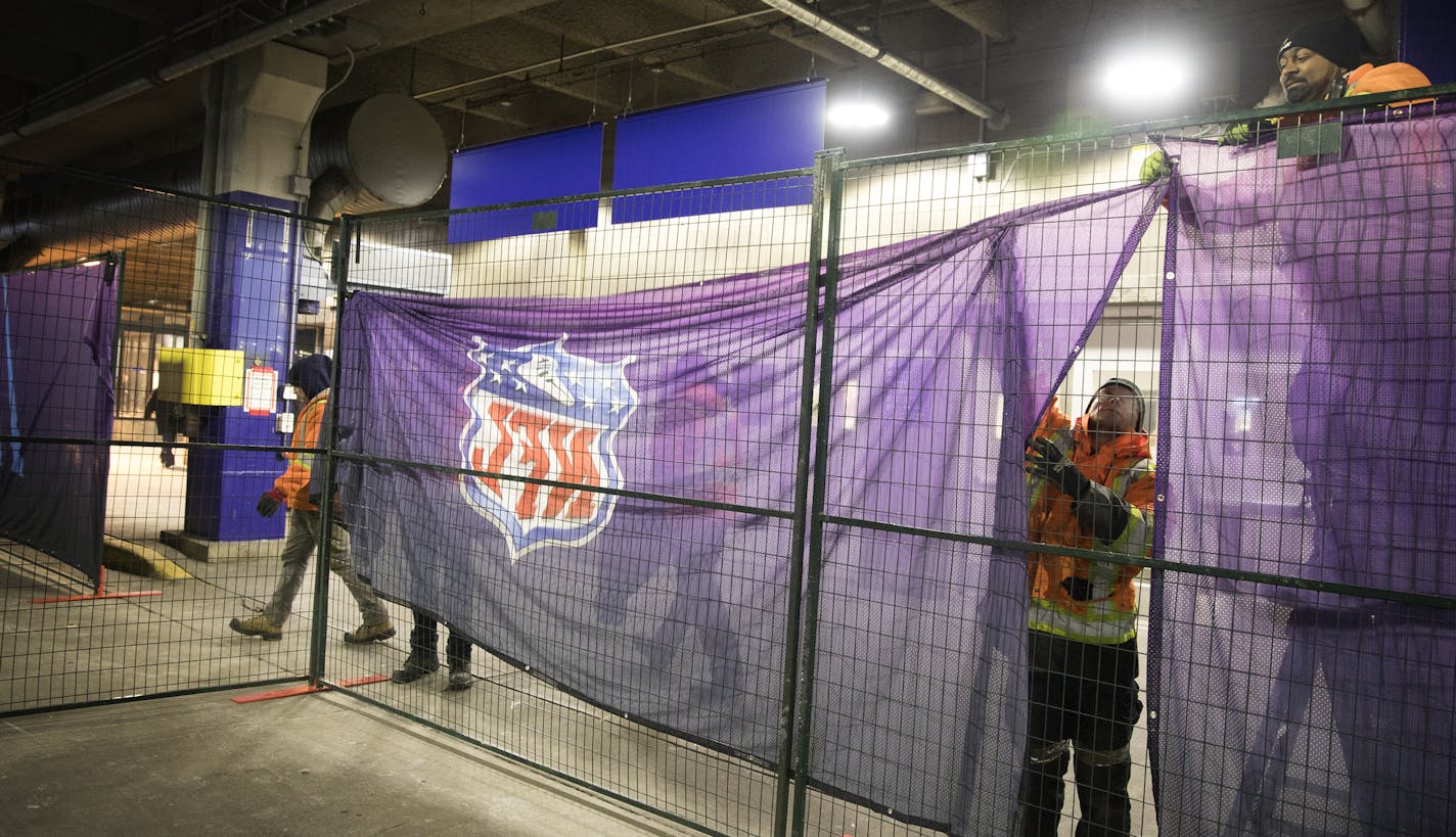 Skippy Narayan, from right, and Alexander Rioux from MODU-LOC USA build a barrier to direct passengers on Sunday without Super Bowl tickets to the bus area at the Mall of America Transit Station. ] LEILA NAVIDI &#xef; leila.navidi@startribune.com BACKGROUND INFORMATION: Mall of America Transit Station in Bloomington on Thursday, February 1, 2018.