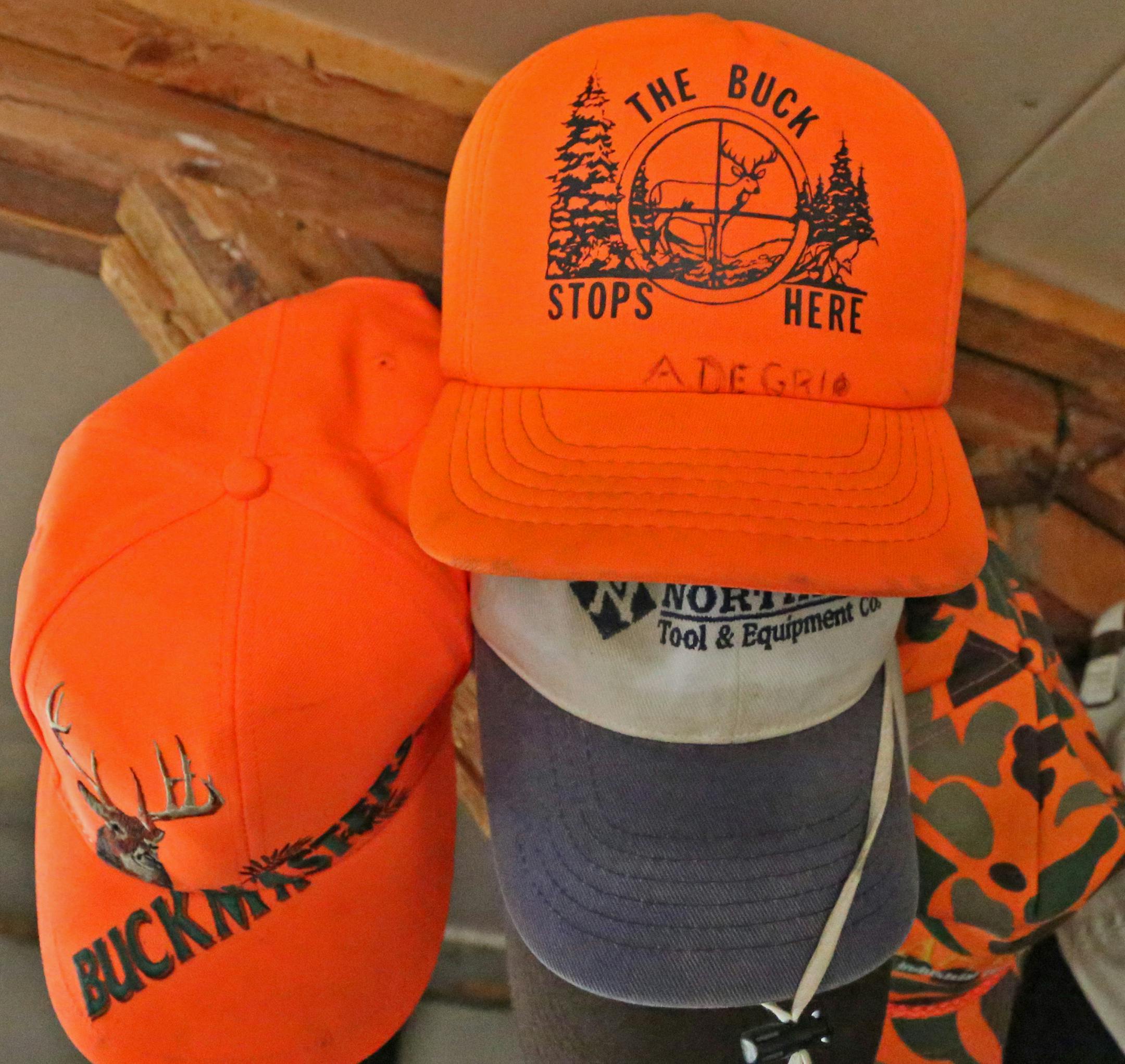 Blaze orange caps hanging in Mike Degrio's hunting shack signify that the target species of hunters staying there is deer.