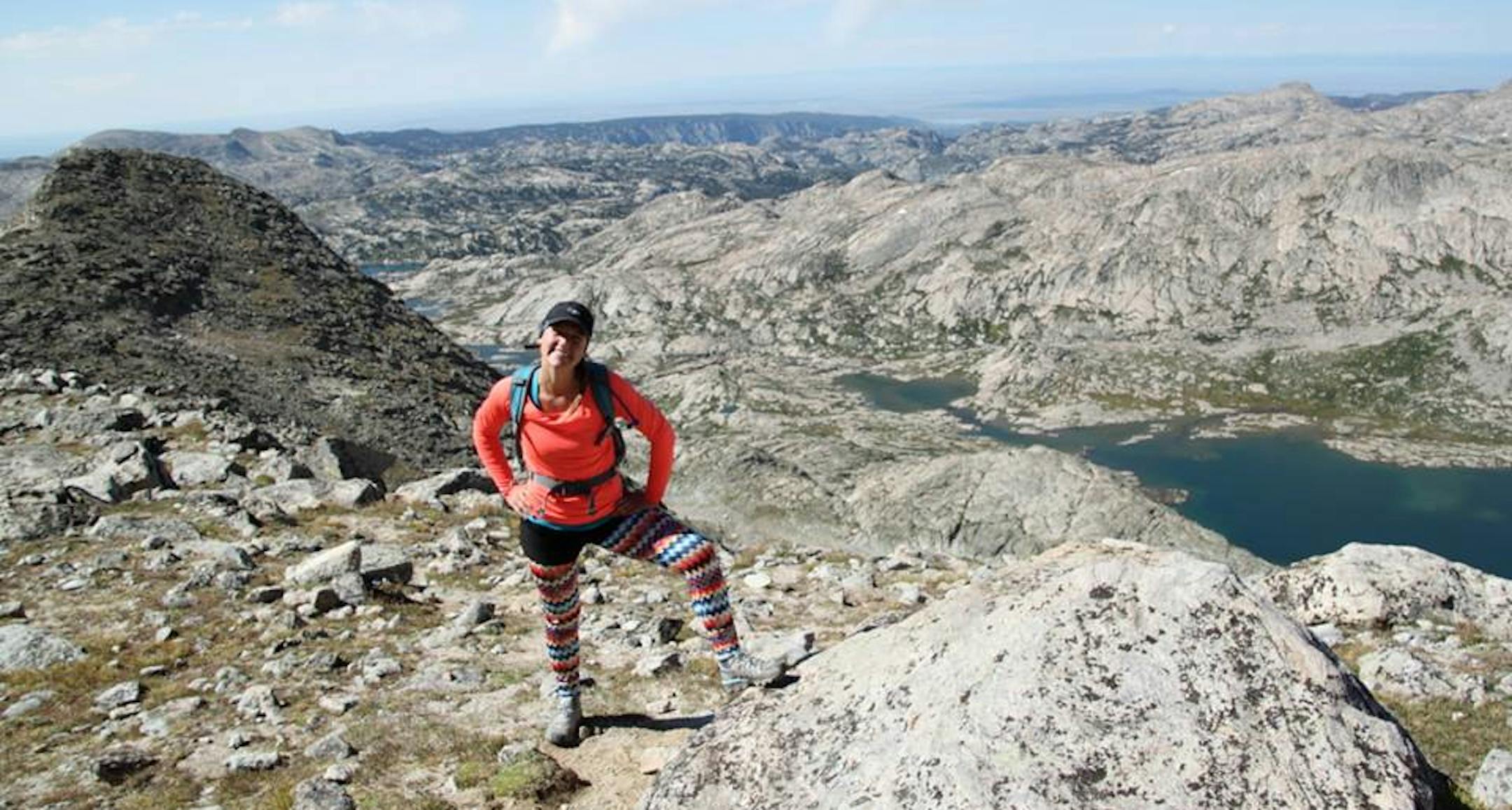 Ashley Melco stands at the summit of Fremont Pass in Colorado.