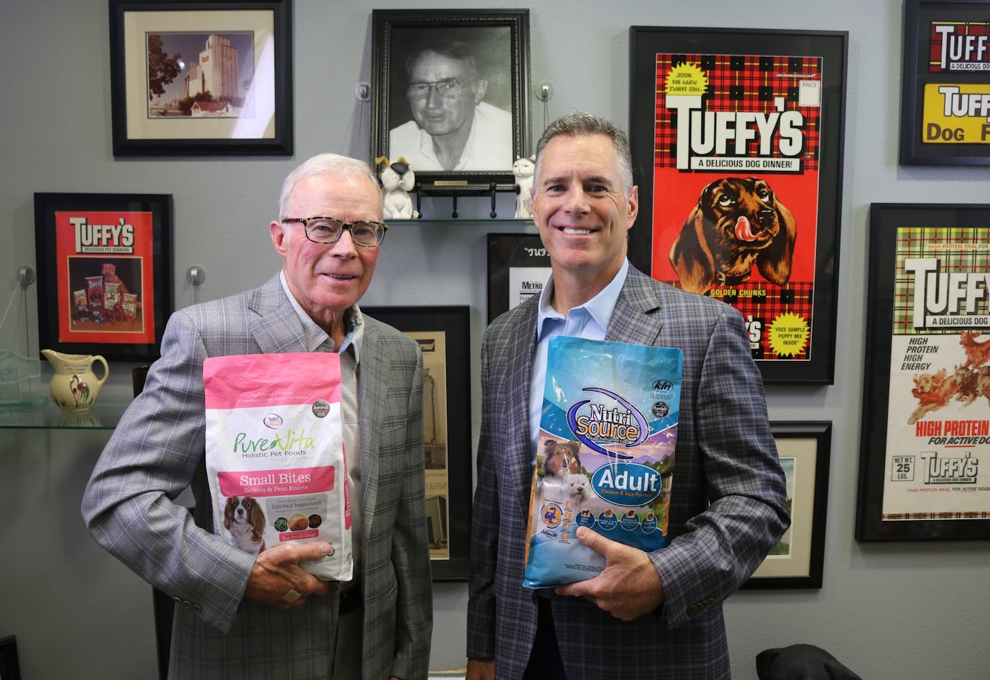 CEO Kenny Nelson, 77, and President Charlie Nelson, 47, of Tuffy's, the expanding pet-food manufacturer based in Perham, Mn. Photo: Tuffy Nelson, the late founder after World War II, is pictured on the wall. Photo:Tuffy's