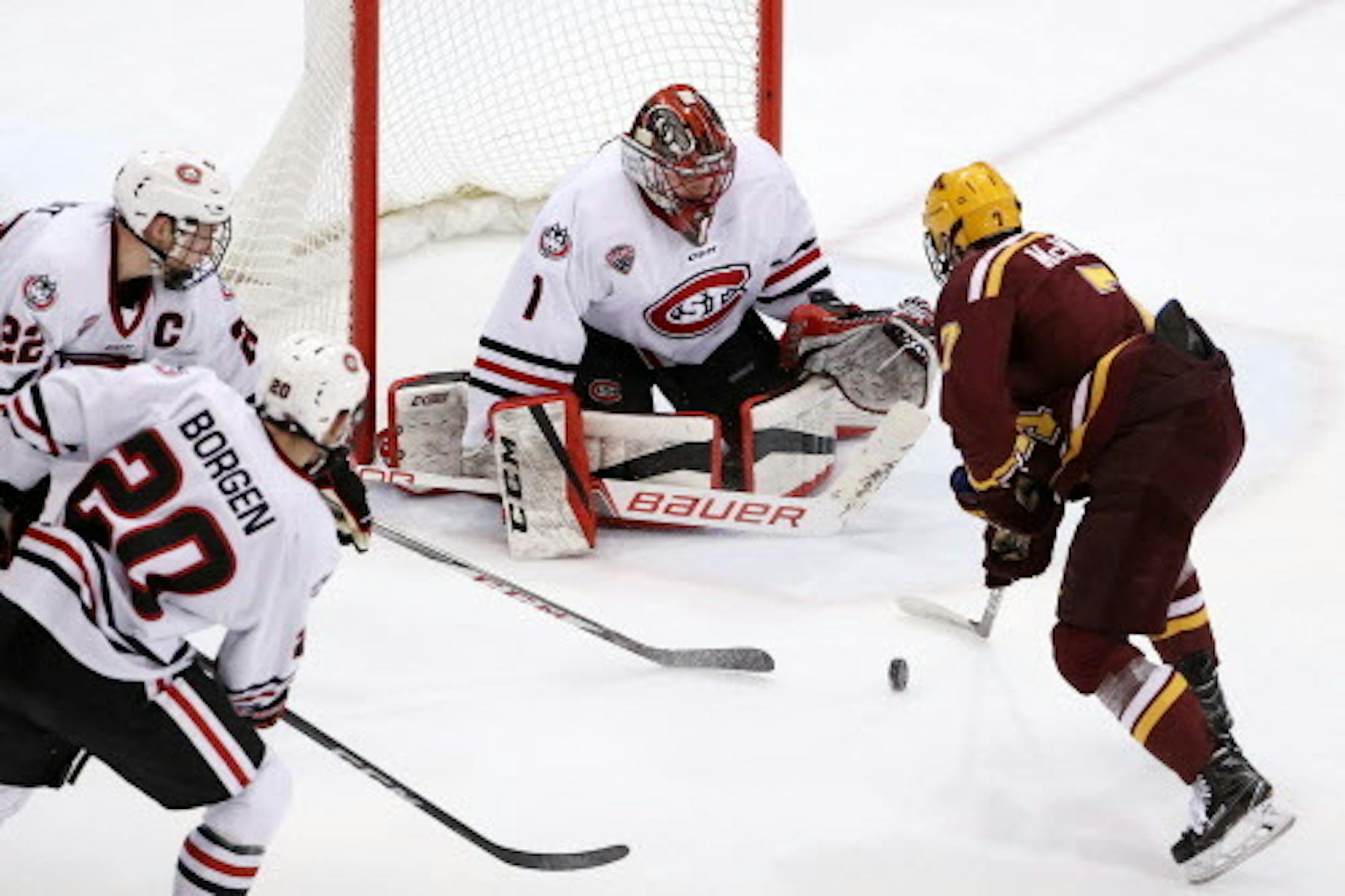 Minnesota Golden Gophers forward Brannon McManus (7) tried to get the puck past St. Cloud State Huskies goaltender Jeff Smith (1) as St. Cloud State Huskies defenseman Jimmy Schuldt (22) and St. Cloud State Huskies defenseman Will Borgen (20) raced to defend in the second period. ] ANTHONY SOUFFLE ' anthony.souffle@startribune.com