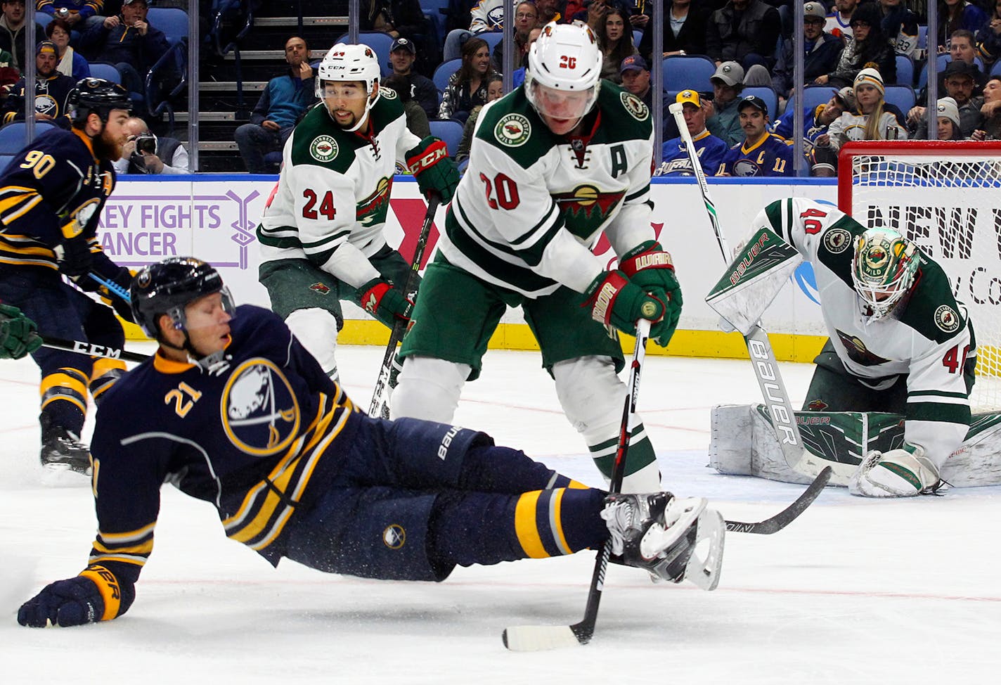 Buffalo Sabres Kyle Okposo (21) is brought down by Minnesota Wild's Ryan Suter (20) during the third period of an NHL hockey game, Thursday, Oct. 27, 2016, in Buffalo, N.Y. (AP Photo/Jeffrey T. Barnes)