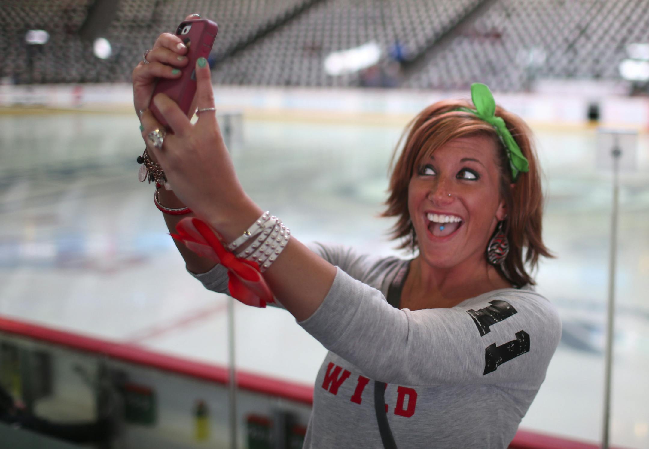 Carrie Burgess was brought to the game by her friend Chris Mordick, who grew up in Stillwater and now lives in Denver. She facetimed with a friend before the game Wednesday night at Pepsi Center in Denver. ] JEFF WHEELER ‚Ä¢ jeff.wheeler@startribune.com The MInnesota Wild faced the Colorado Avalanche in game 7 of their NHL opening round playoff series Wednesday night, April 29, 2014, at Pepsi Center in Denver.